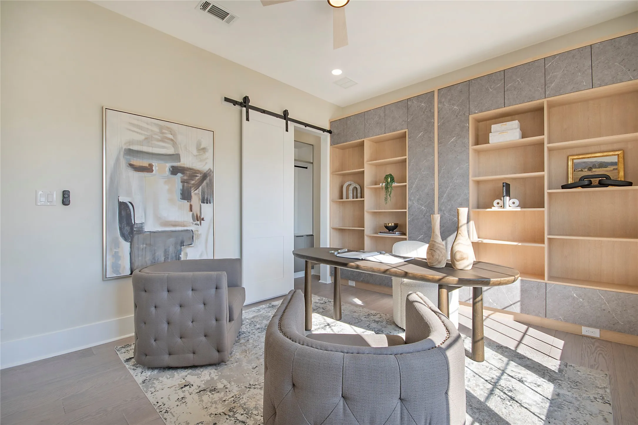 Home office with a barn door, wood finished floors, a ceiling fan, and recessed lighting