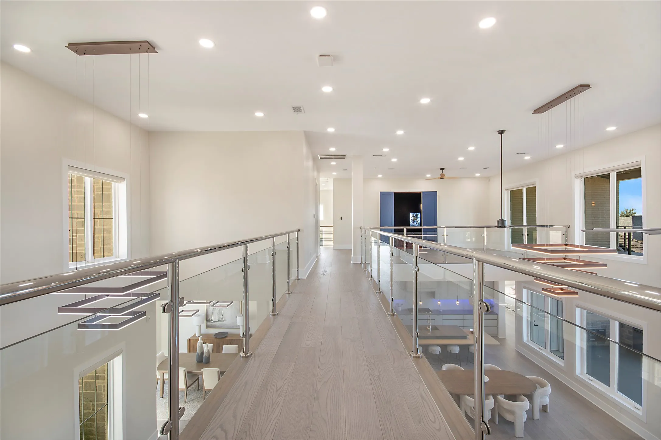 Hall featuring light wood-type flooring, recessed lighting, and an upstairs landing