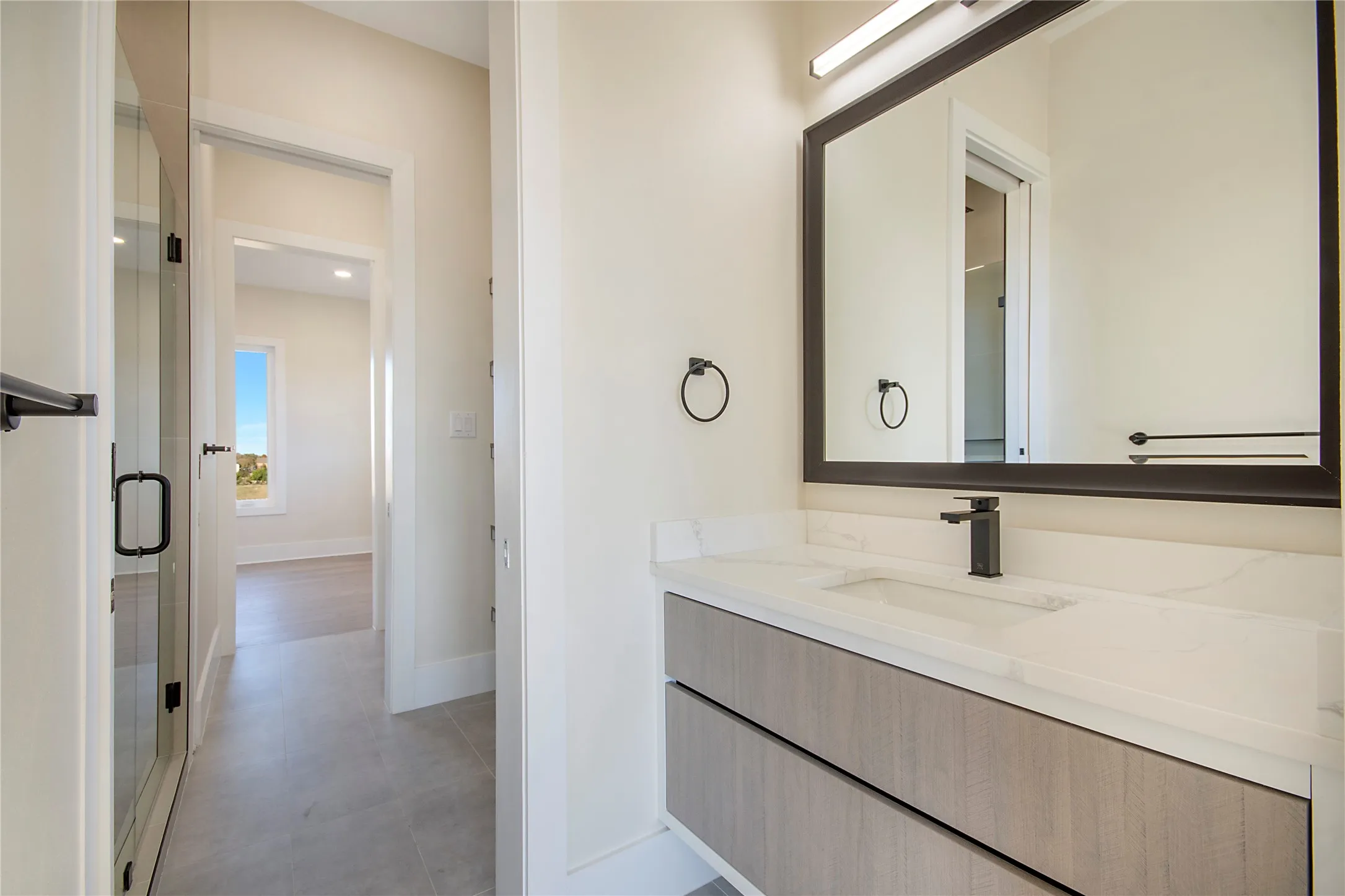 Full bathroom with vanity and a shower stall