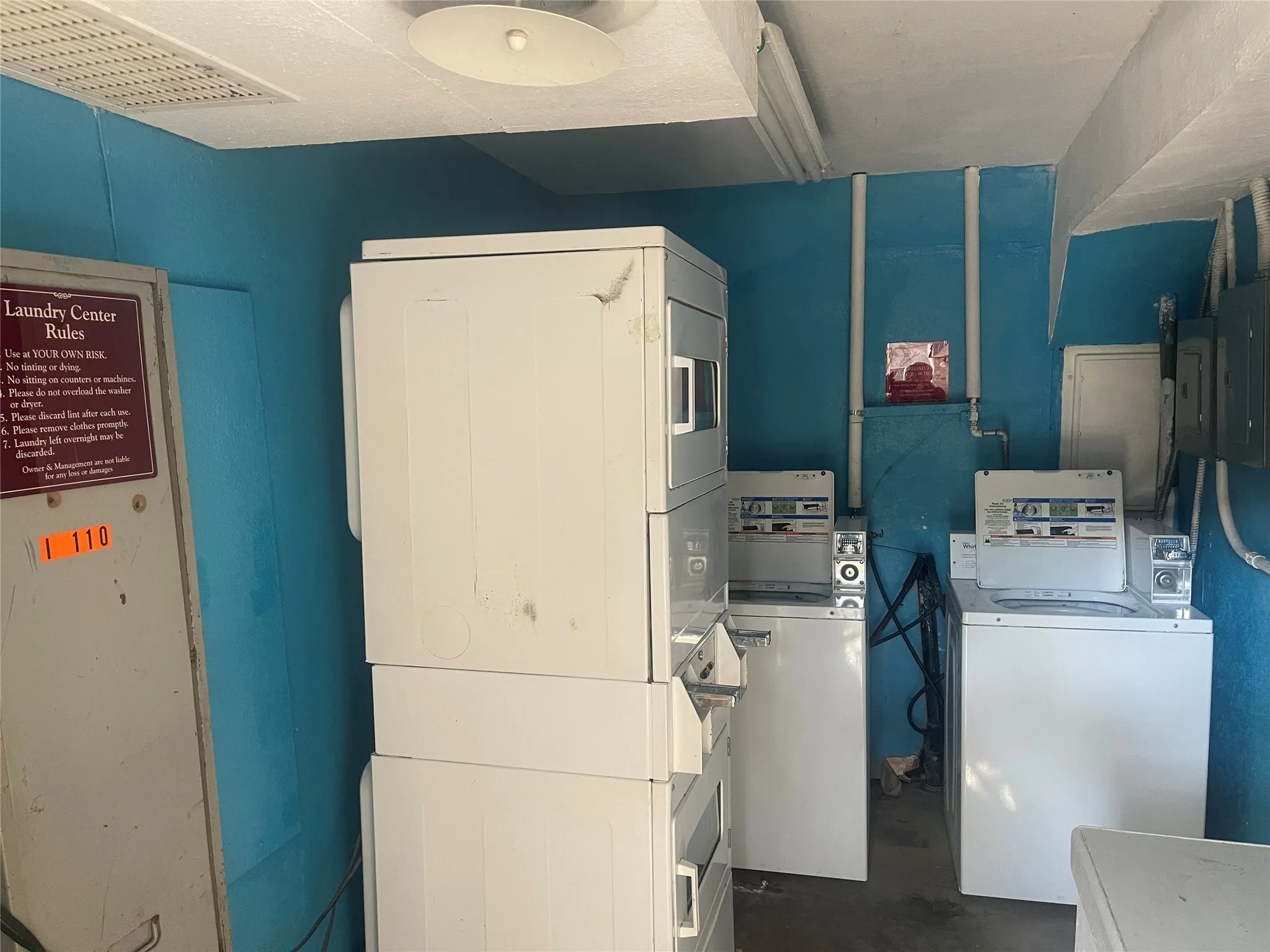 Shared laundry room with concrete floors