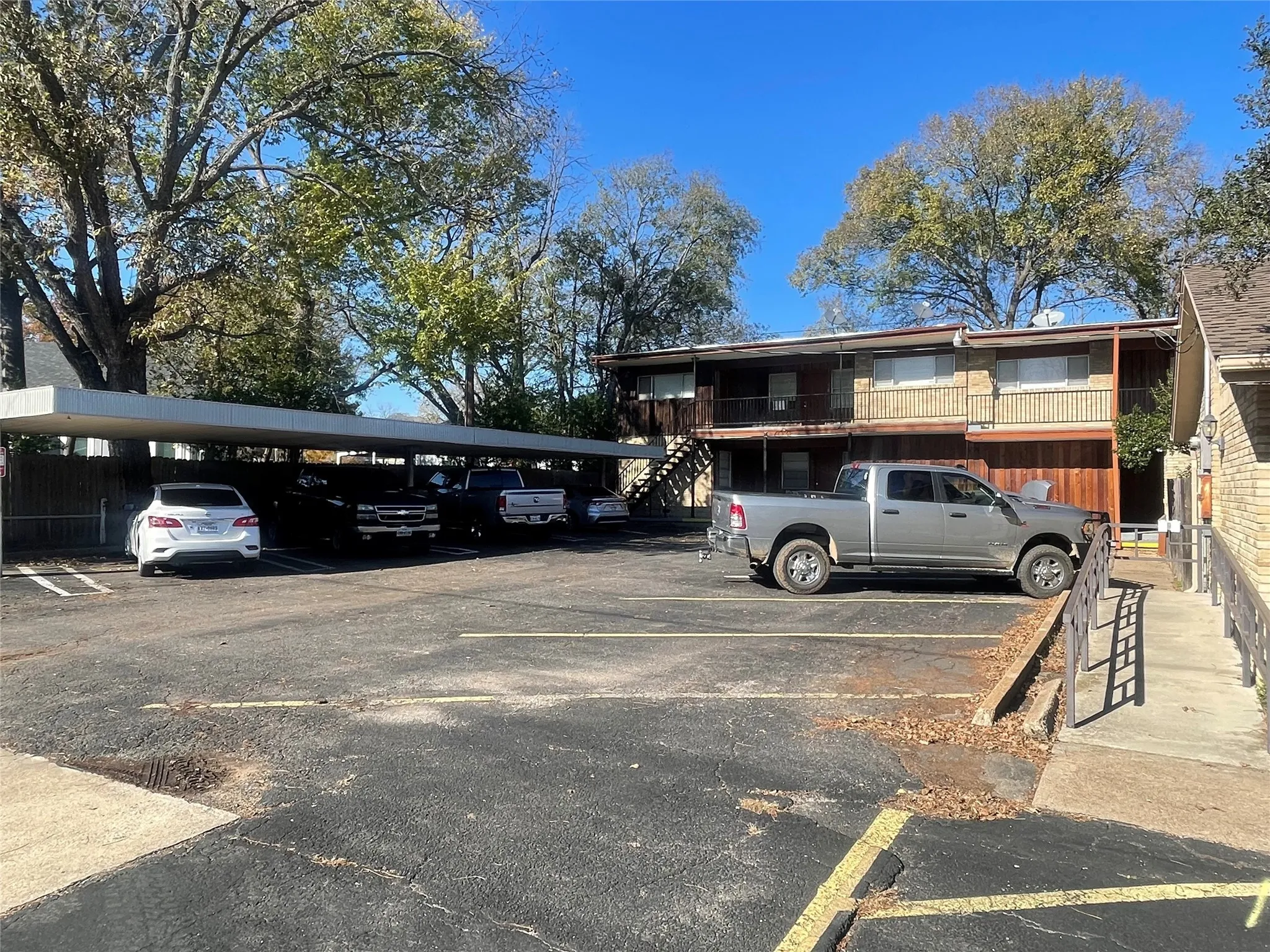 Partially covered parking lot featuring stairway
