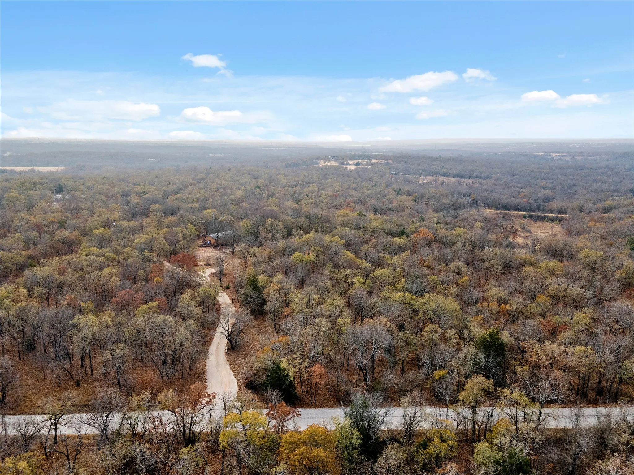 View of property location featuring a heavily wooded area