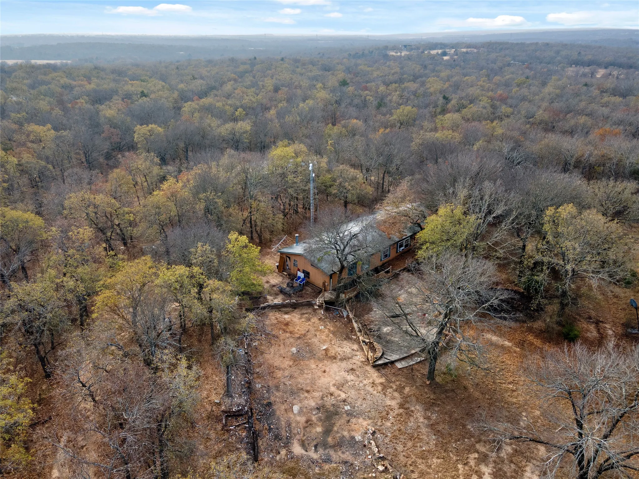 View from above of property featuring a heavily wooded area