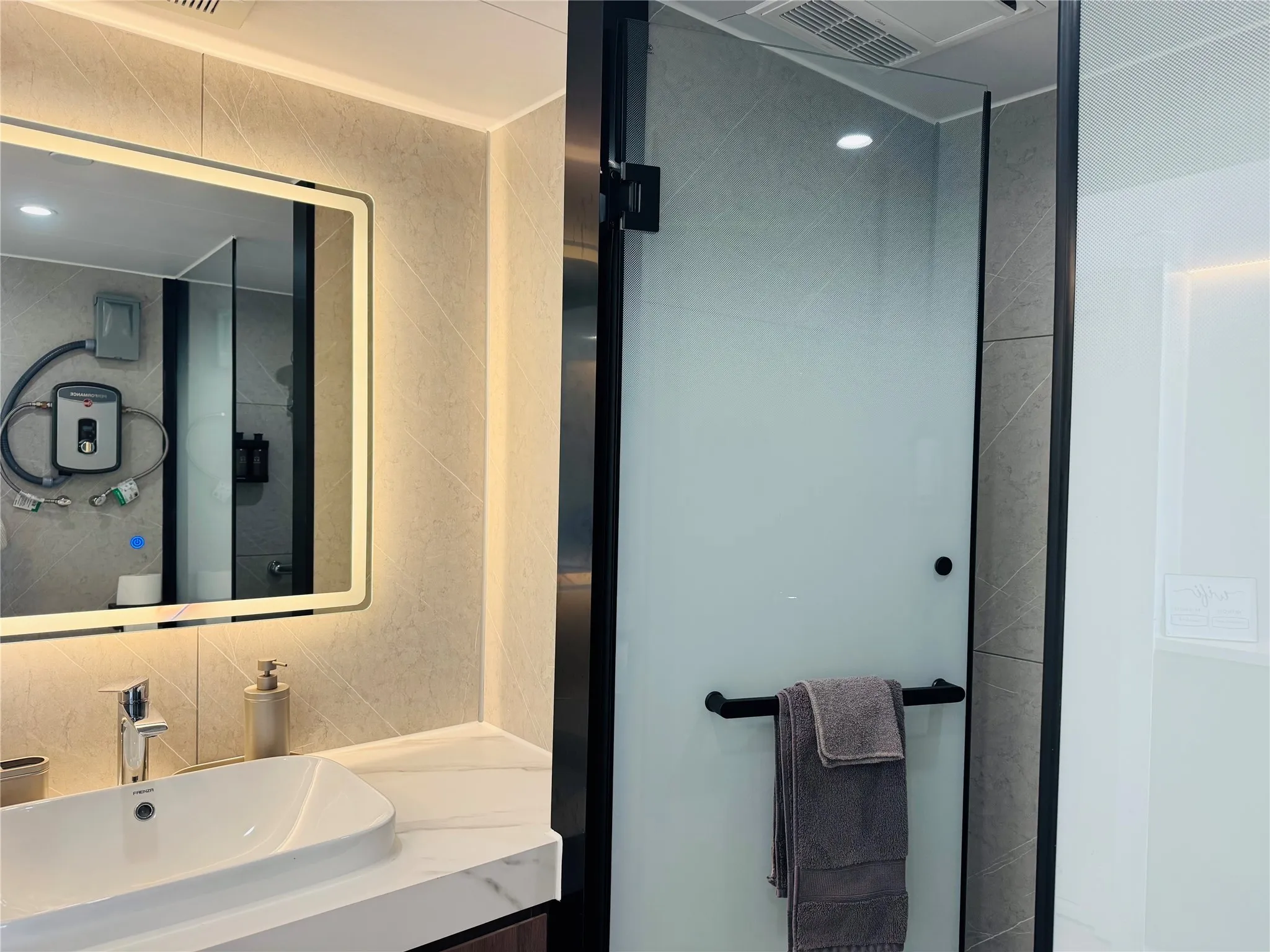 Bathroom featuring vanity, tile walls, a shower stall, and backsplash