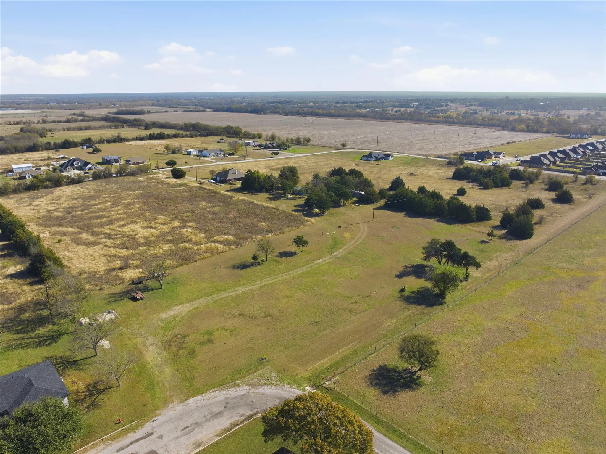 Aerial view of property and surrounding area featuring rural landscape