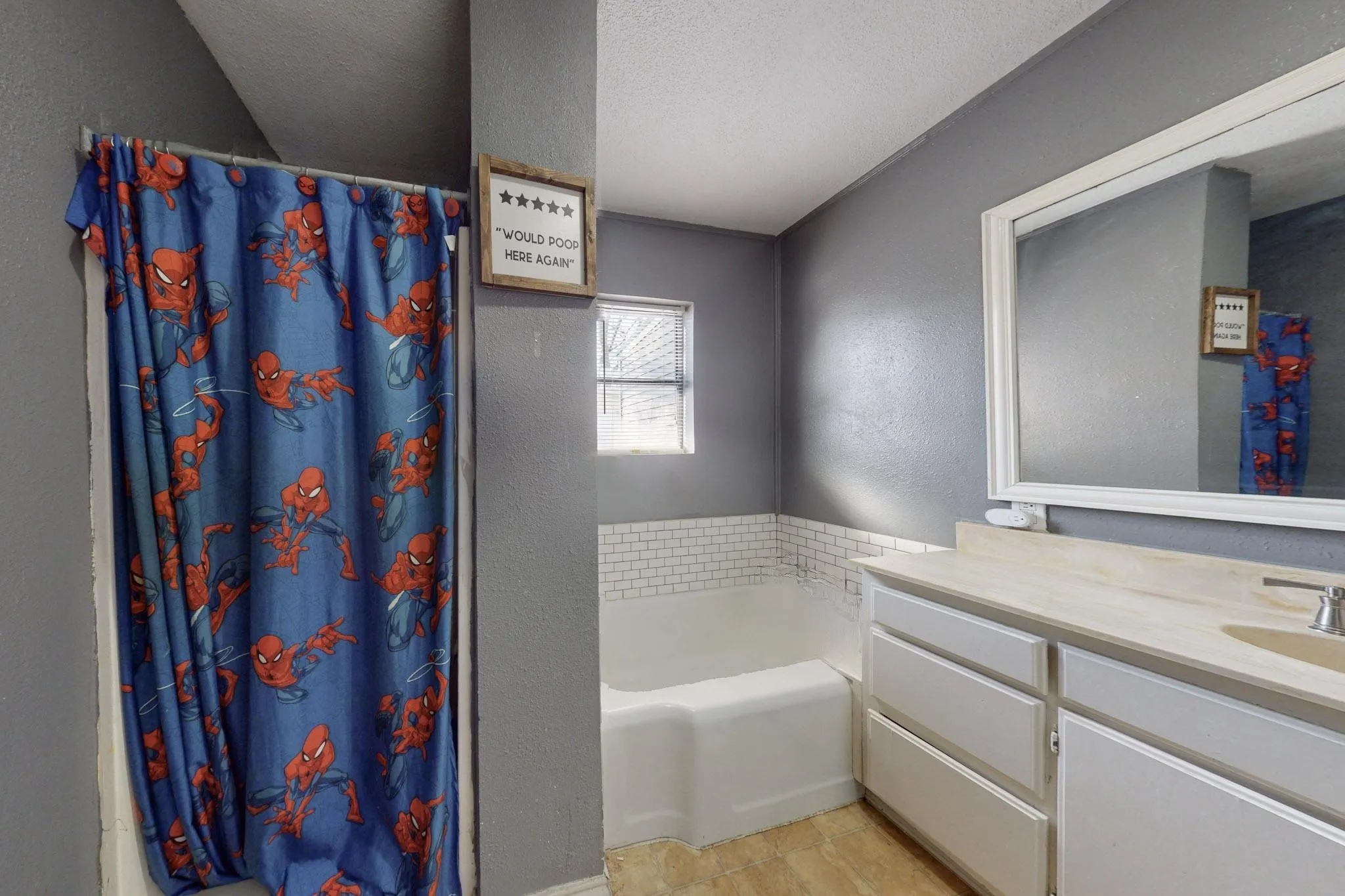 Bathroom featuring a textured wall, a garden tub, a textured ceiling, vanity, and a shower stall
