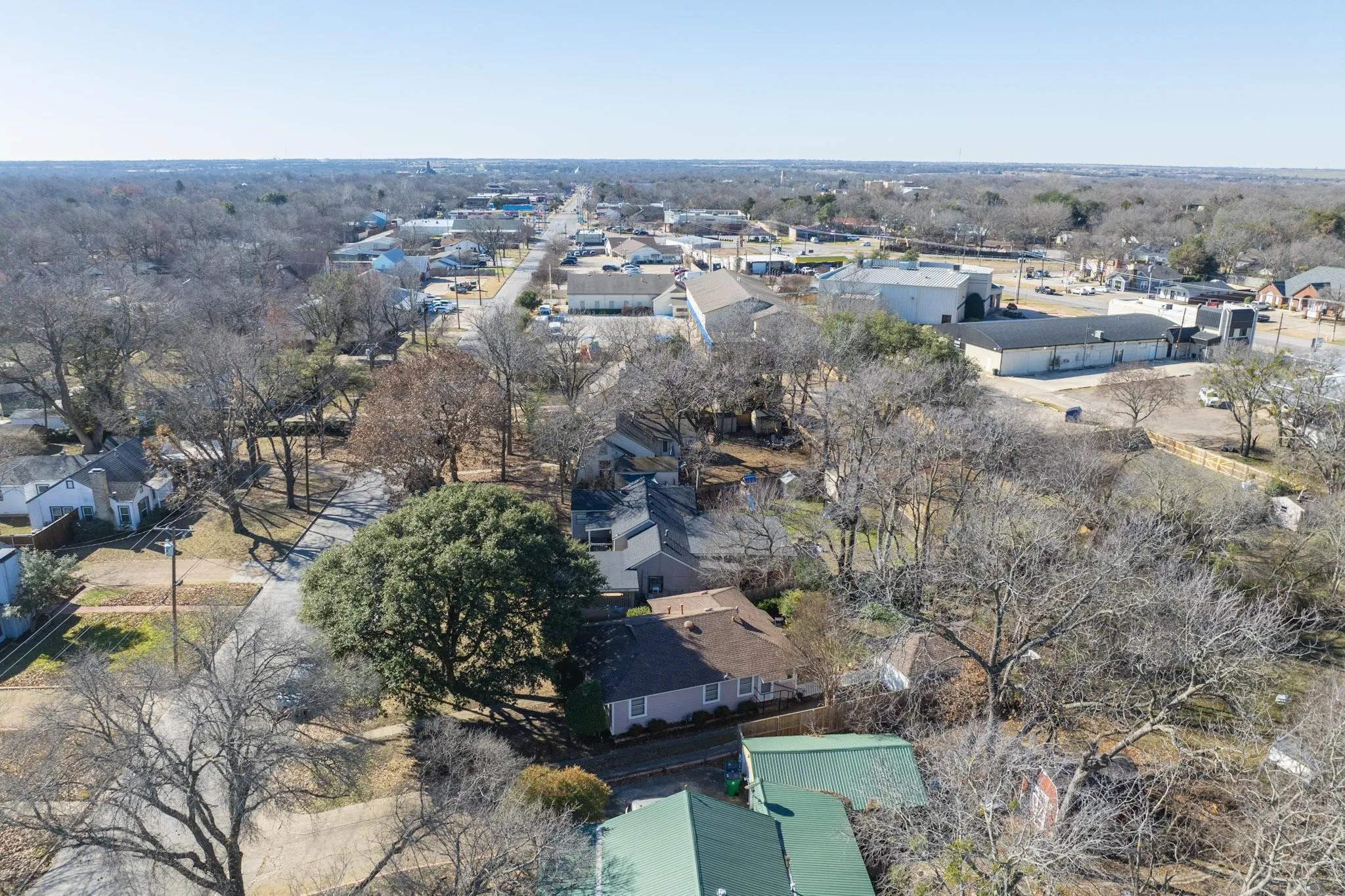 Aerial overview of property's location featuring nearby suburban area