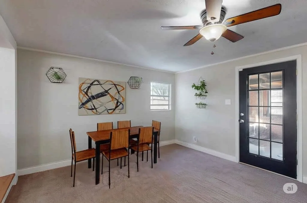 Dining room featuring ornamental molding, light colored carpet, and a ceiling fan