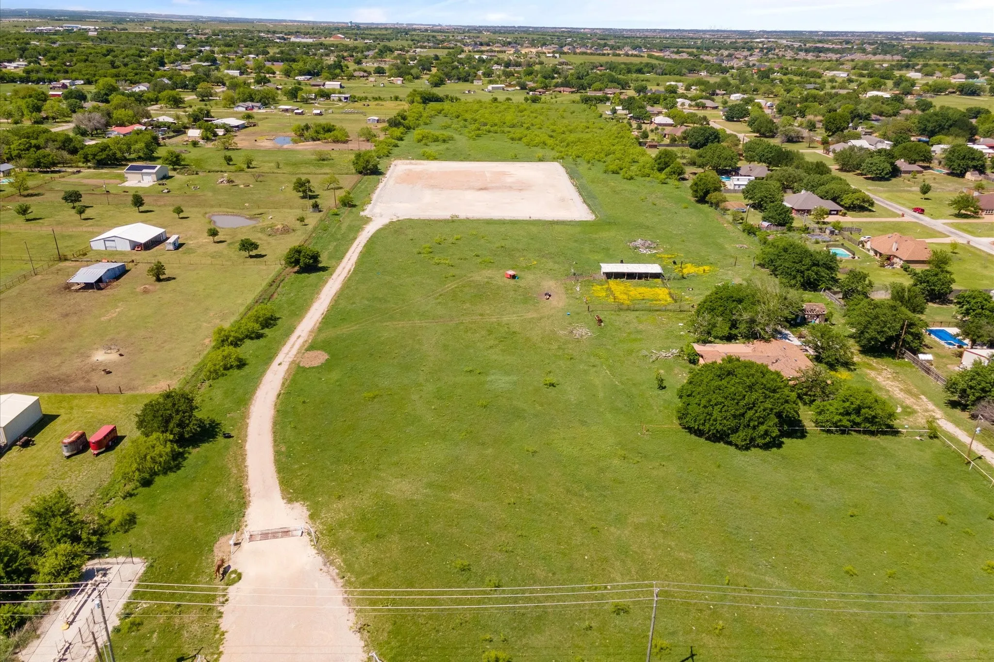 Aerial view of sparsely populated area featuring a pastoral area