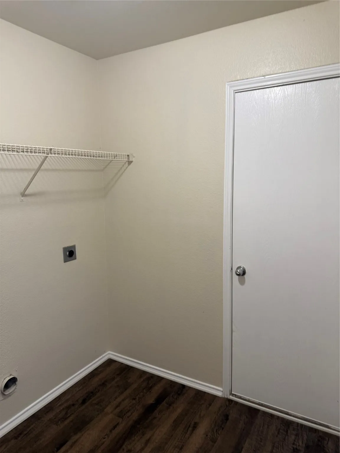 Laundry area featuring electric dryer hookup and dark wood finished floors