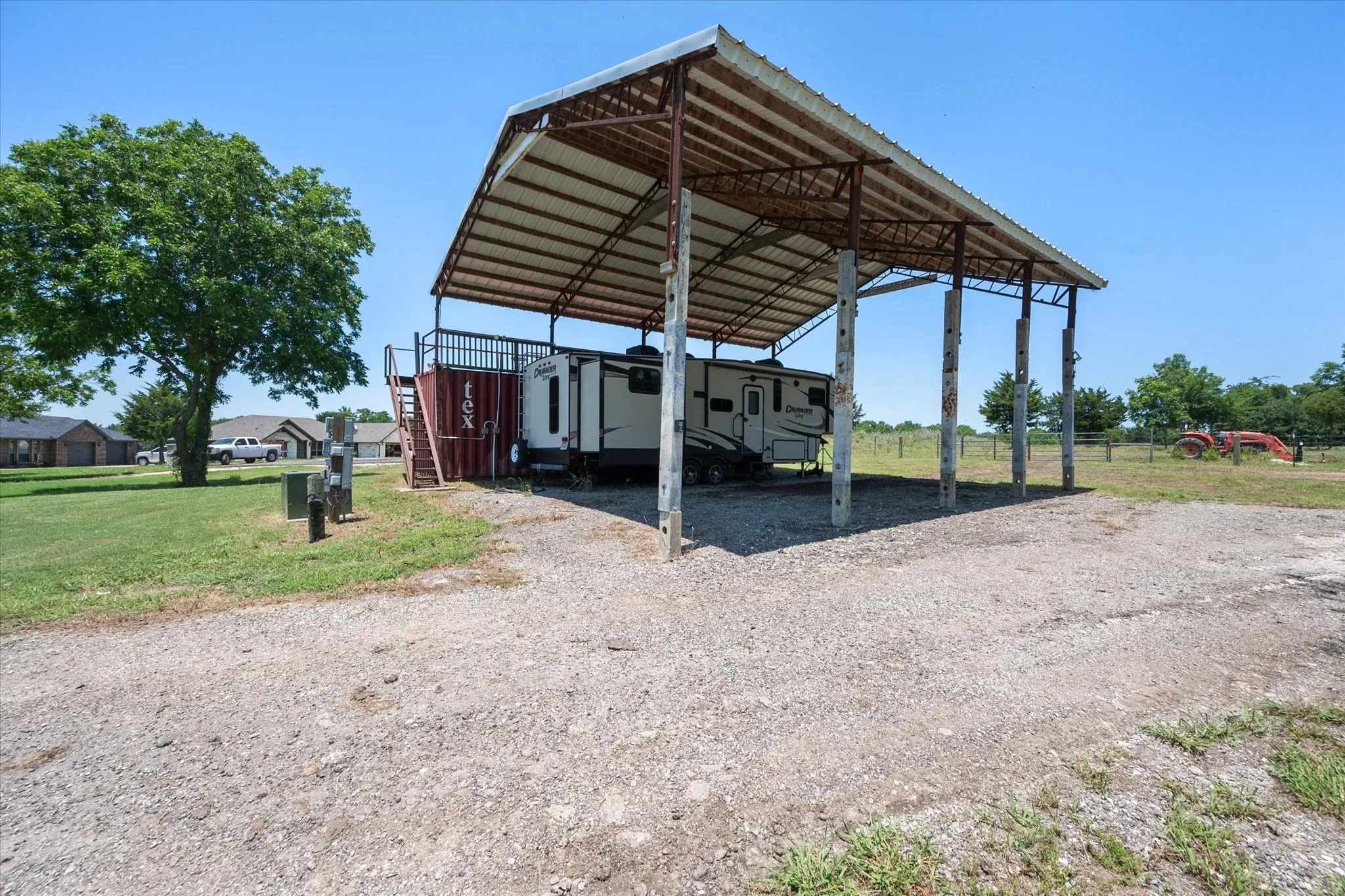 View of parking / parking lot featuring driveway and a carport