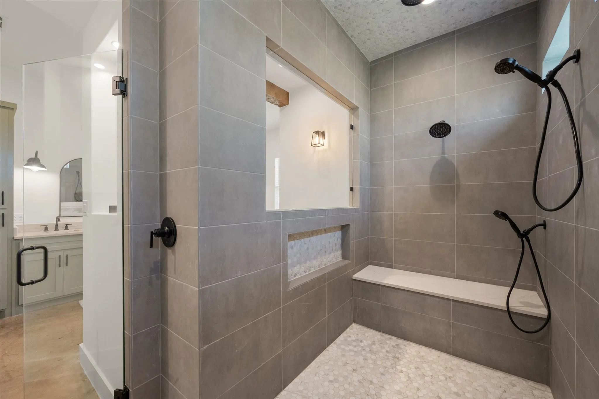 Full bathroom featuring a tile shower, vanity, and recessed lighting