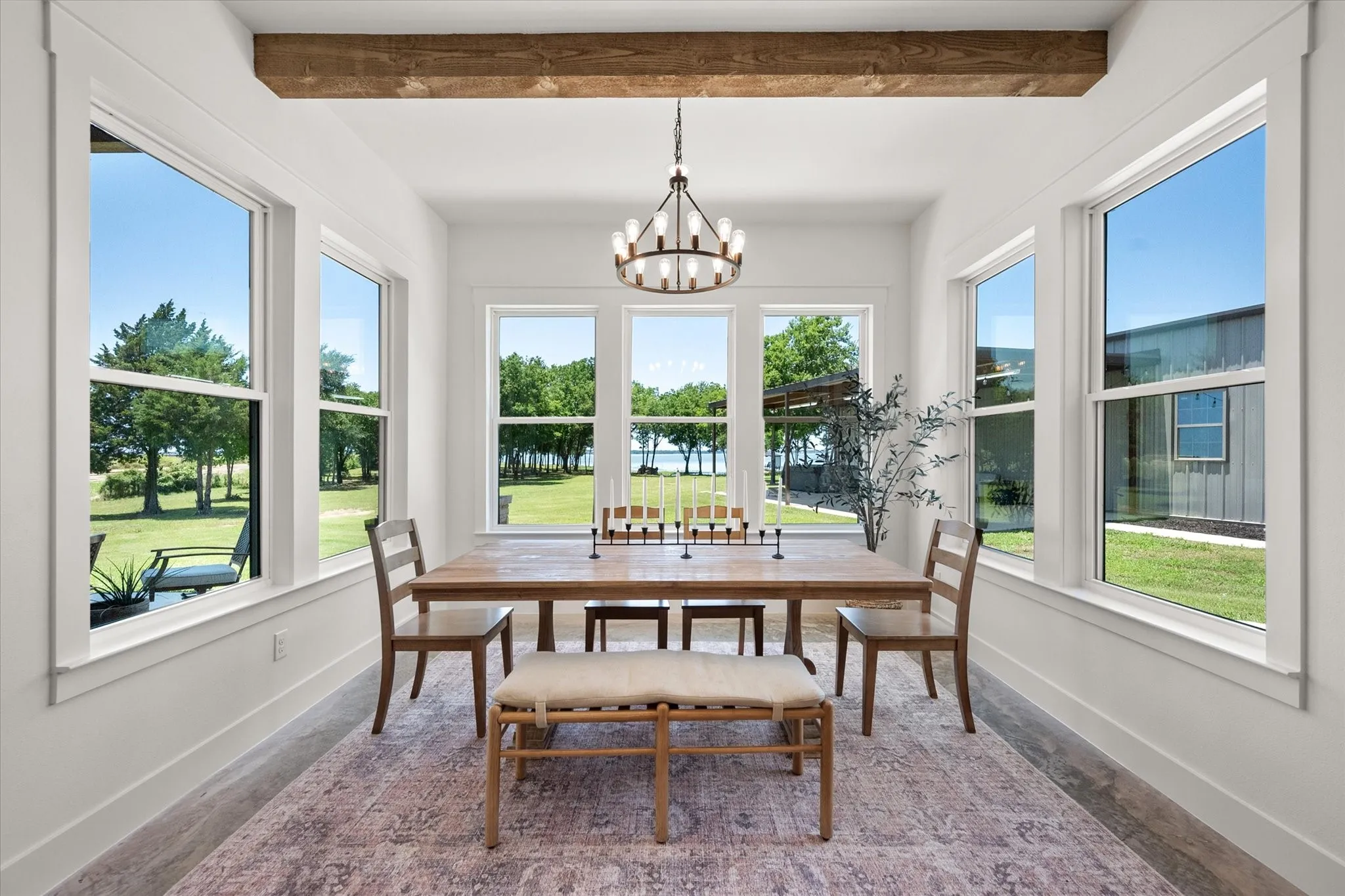 Sunroom featuring a chandelier and beamed ceiling