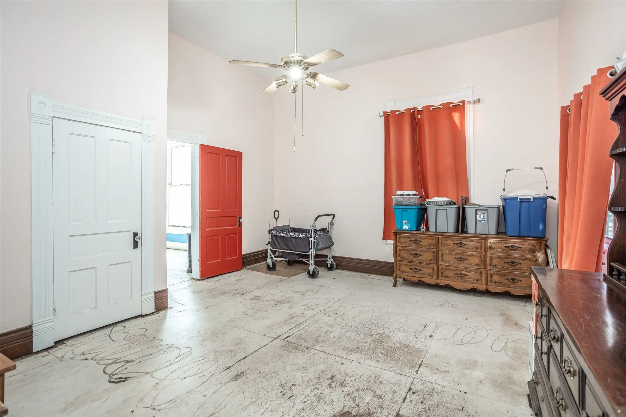 Bedroom with a ceiling fan and a towering ceiling