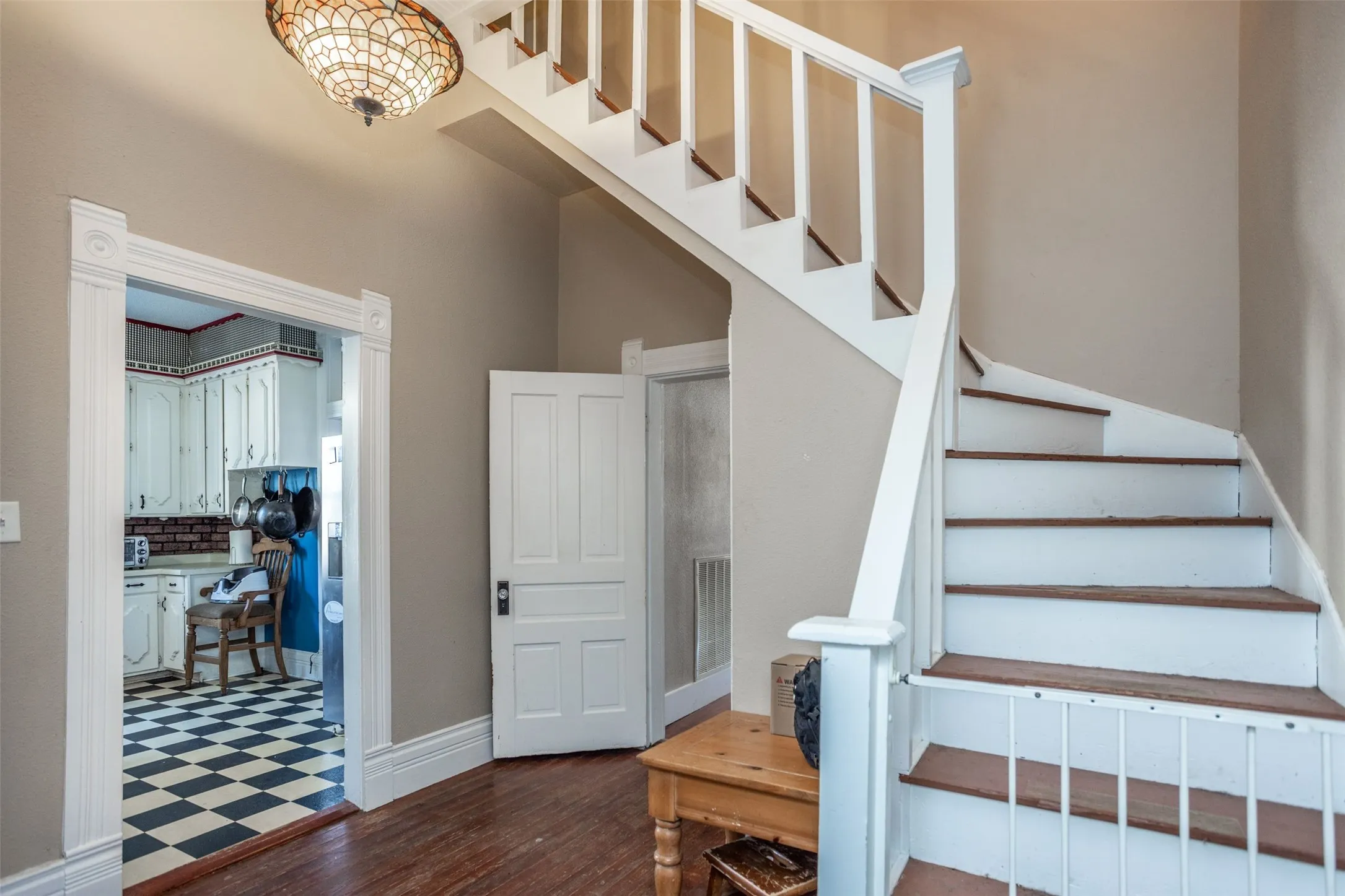 Stairs with hardwood / wood-style flooring and baseboards