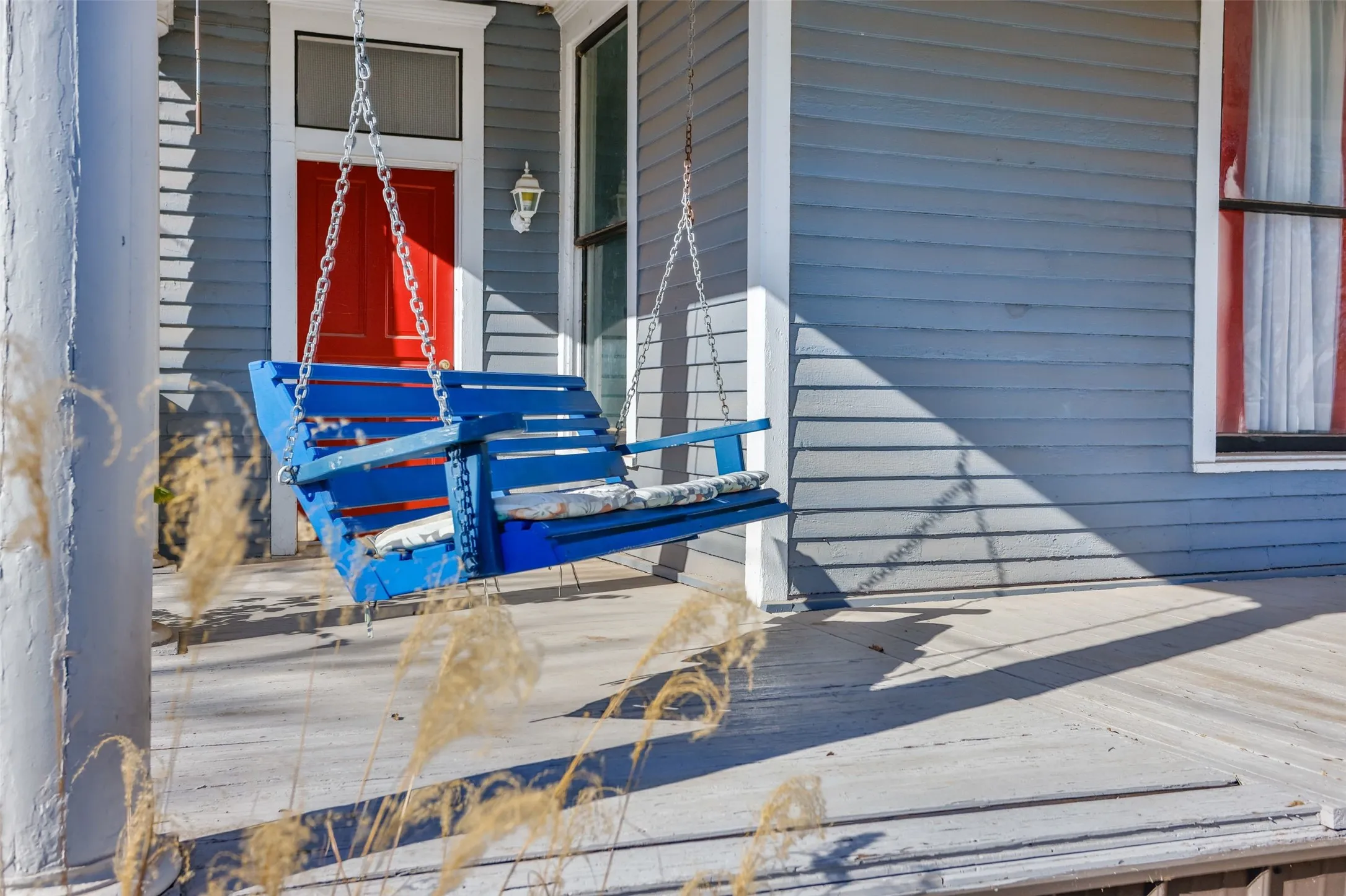 Doorway to property featuring covered porch