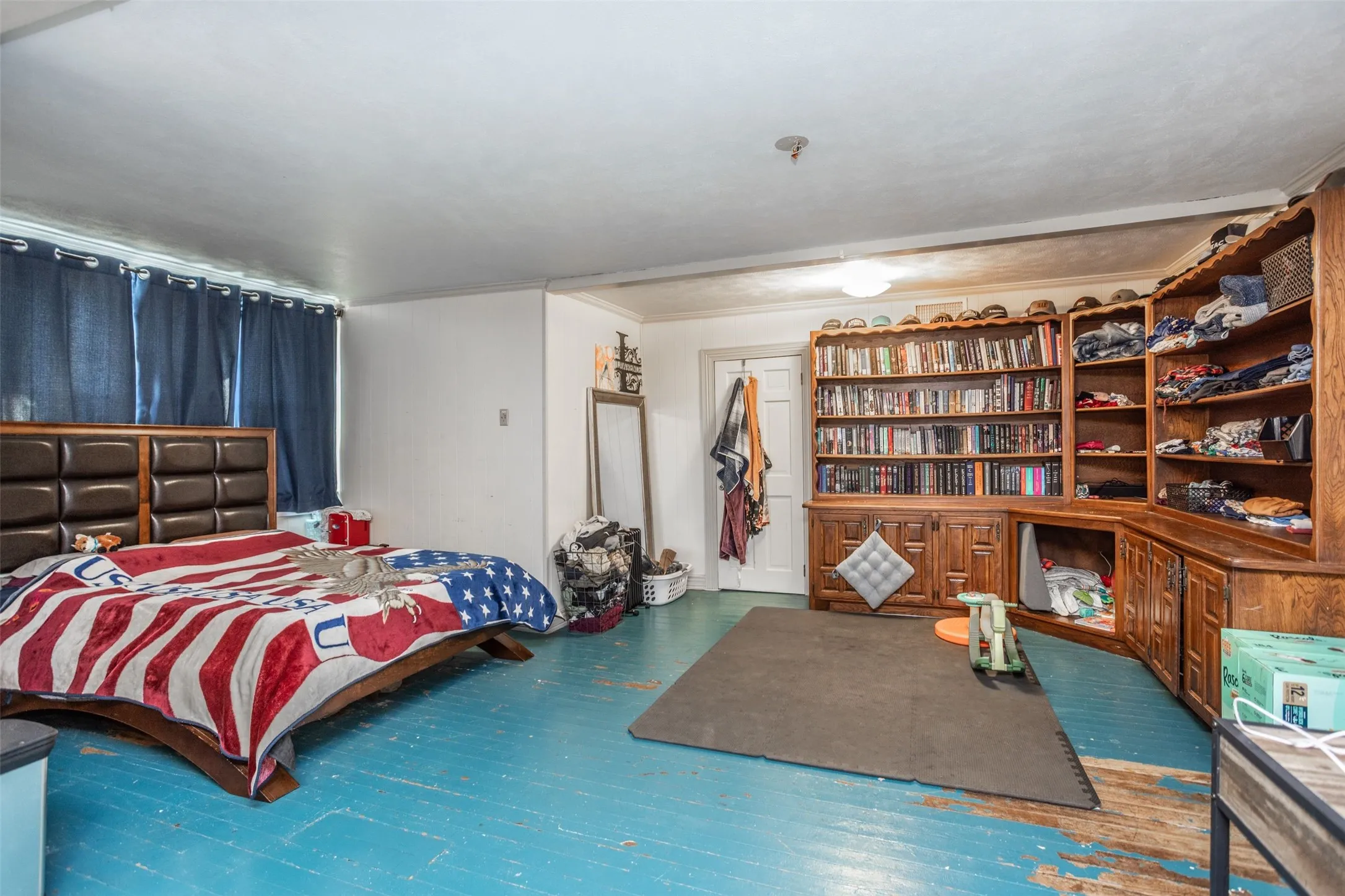 Upstairs Bedroom with ornamental molding, hardwood flooring and built in shelving