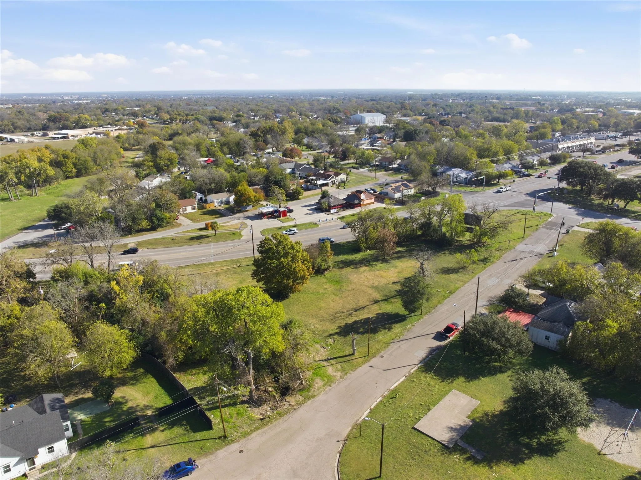 Aerial overview of property's location with a tree filled landscape