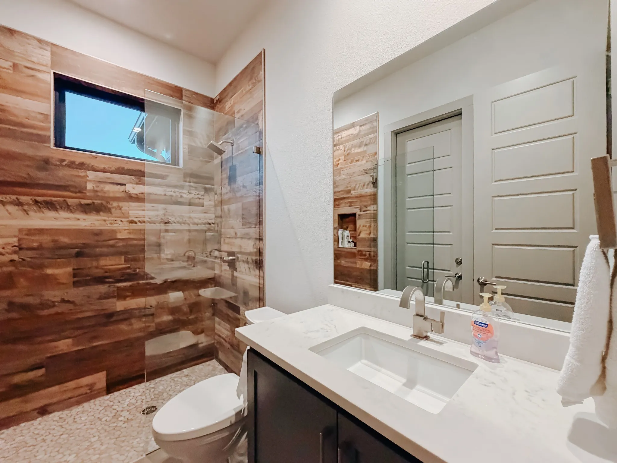 1st floor full guest bathroom with door from patio