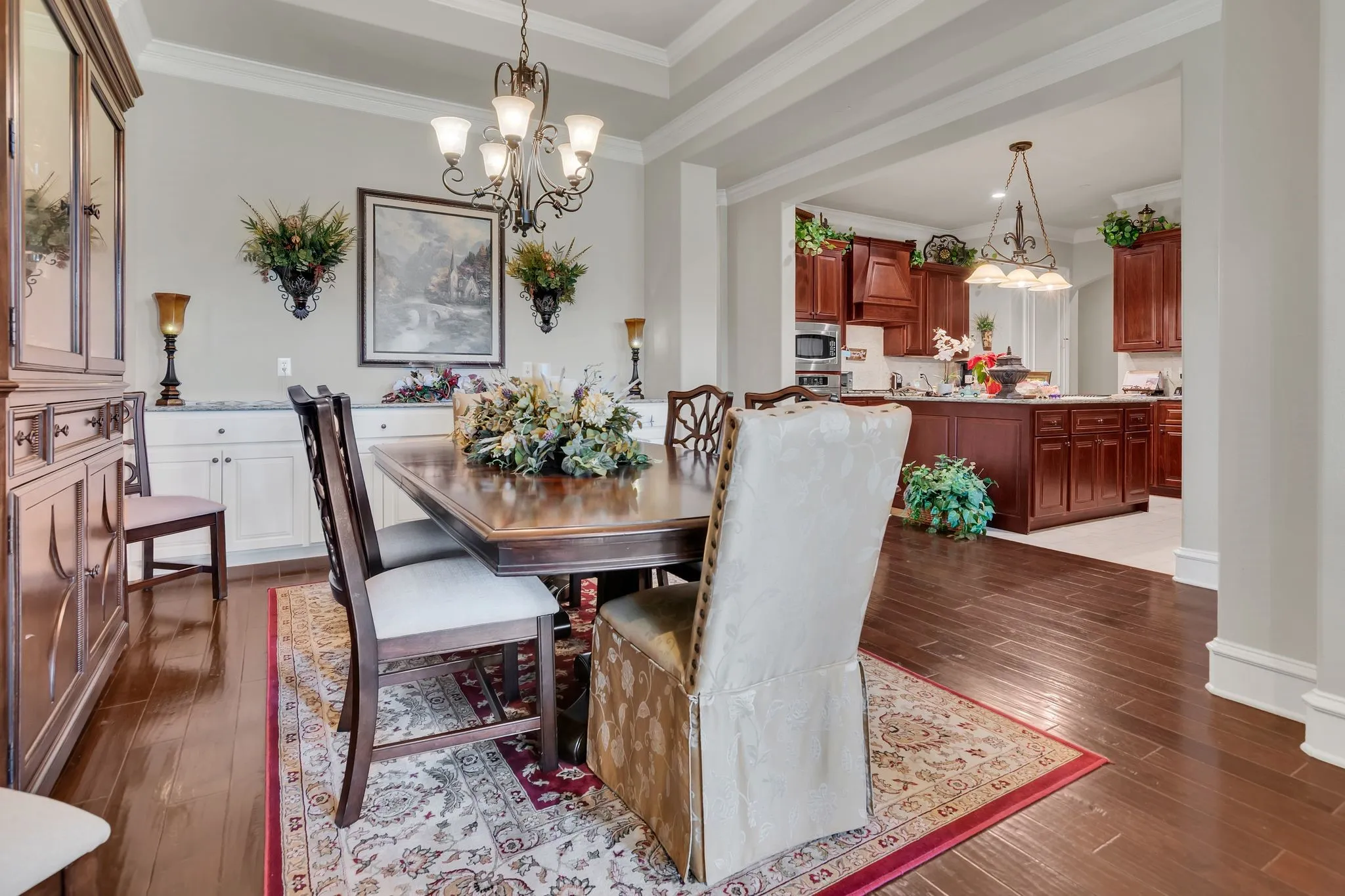 Dining area featuring crown molding, dark wood finished floors, and a chandelier