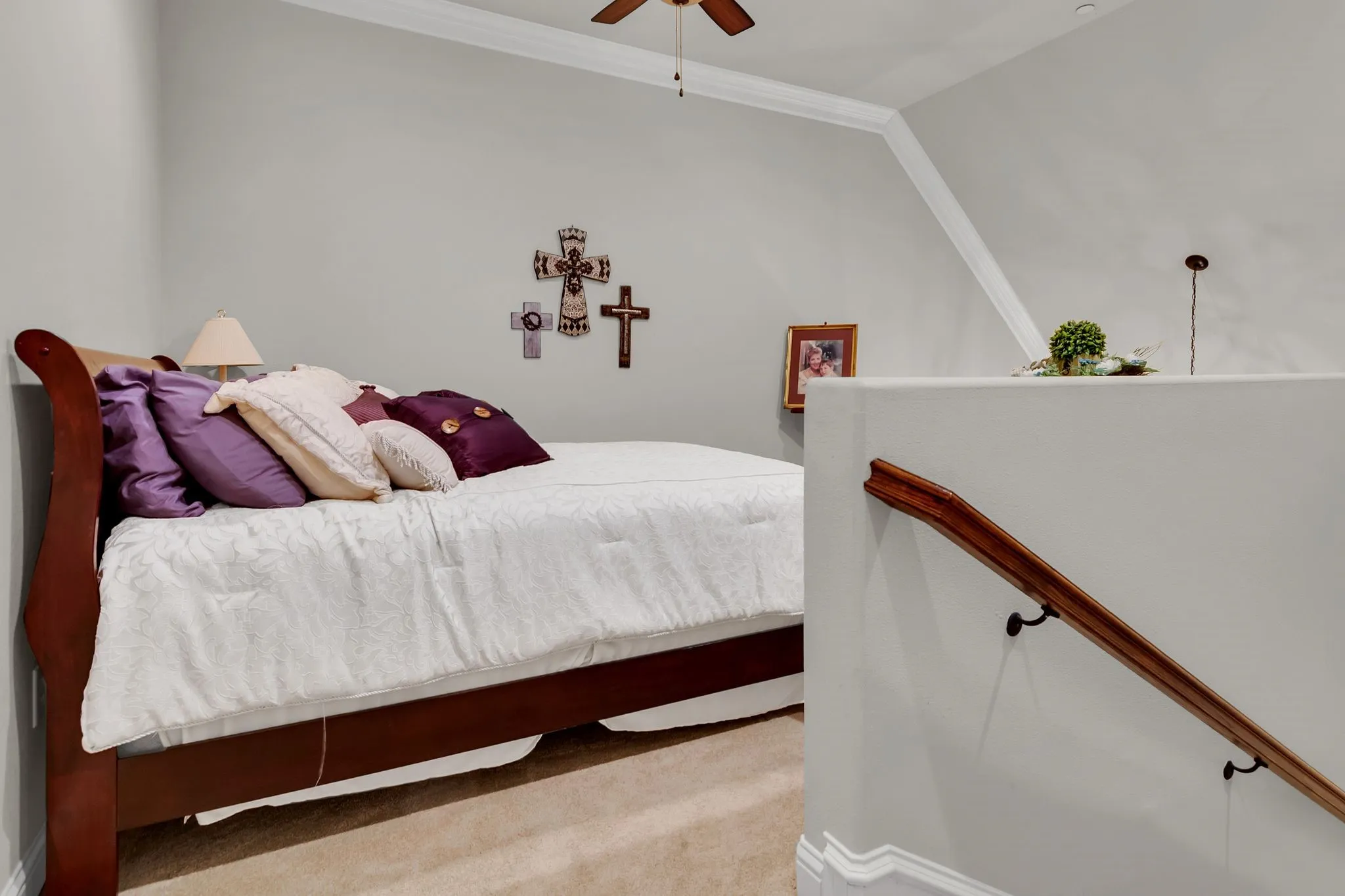 Bedroom featuring light carpet, ceiling fan, and crown molding
