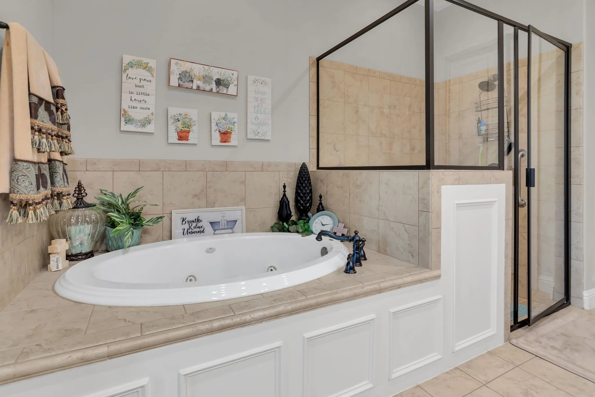 Full bath featuring a jetted whirlpool tub, a shower stall, and light tile patterned floors