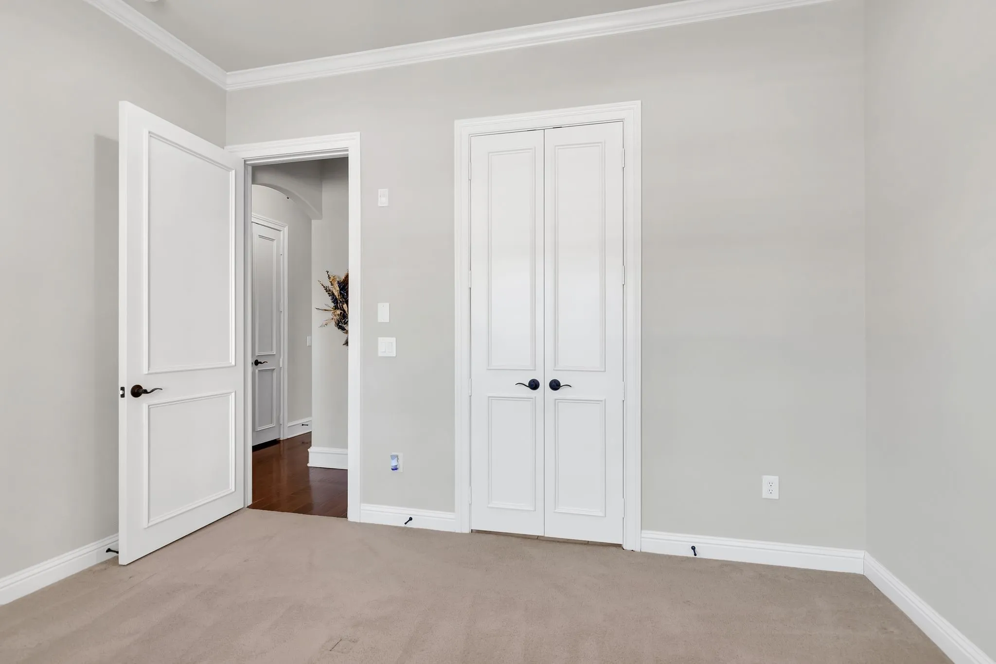 2nd bedroom featuring carpet, crown molding