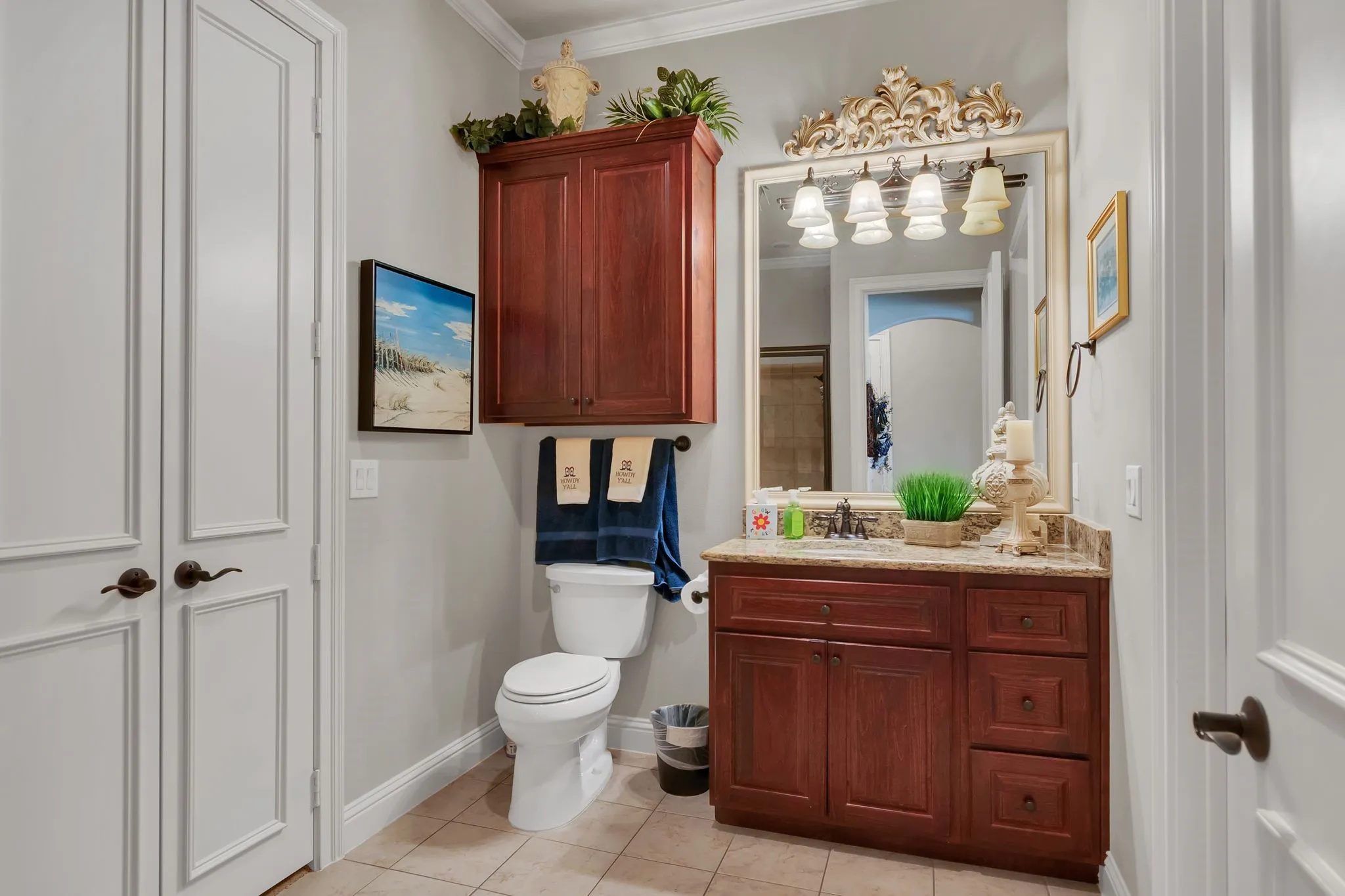 Full bathroom with ornamental molding, vanity, and light tile patterned floors