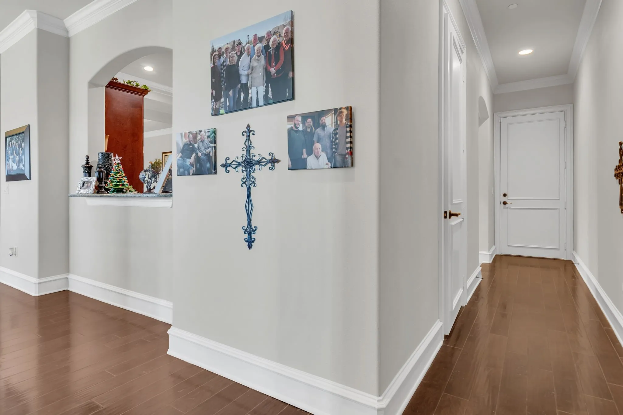 Hallway featuring ornamental molding, dark wood-style floors, and recessed lighting