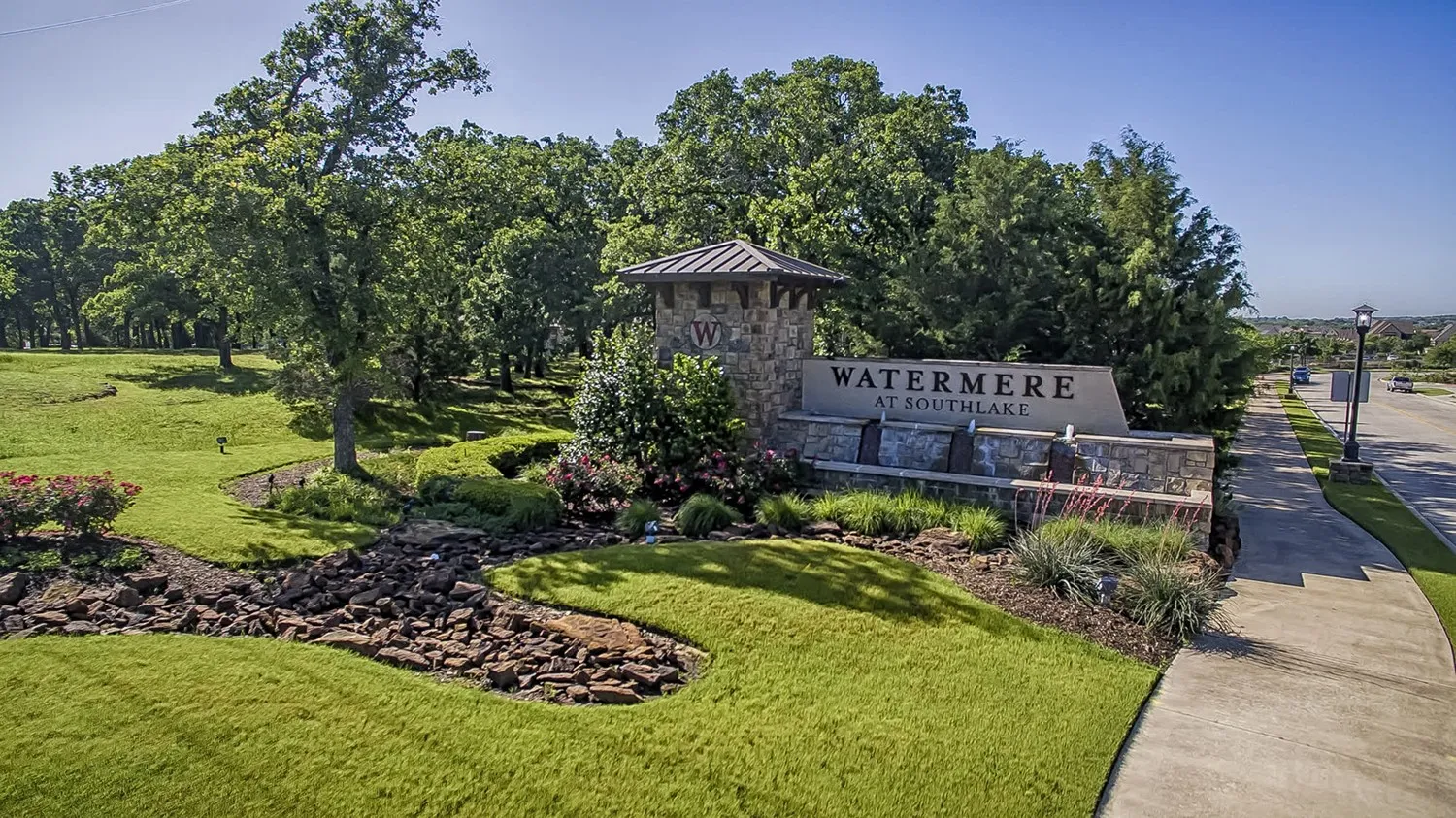 Community / neighborhood sign featuring a lawn