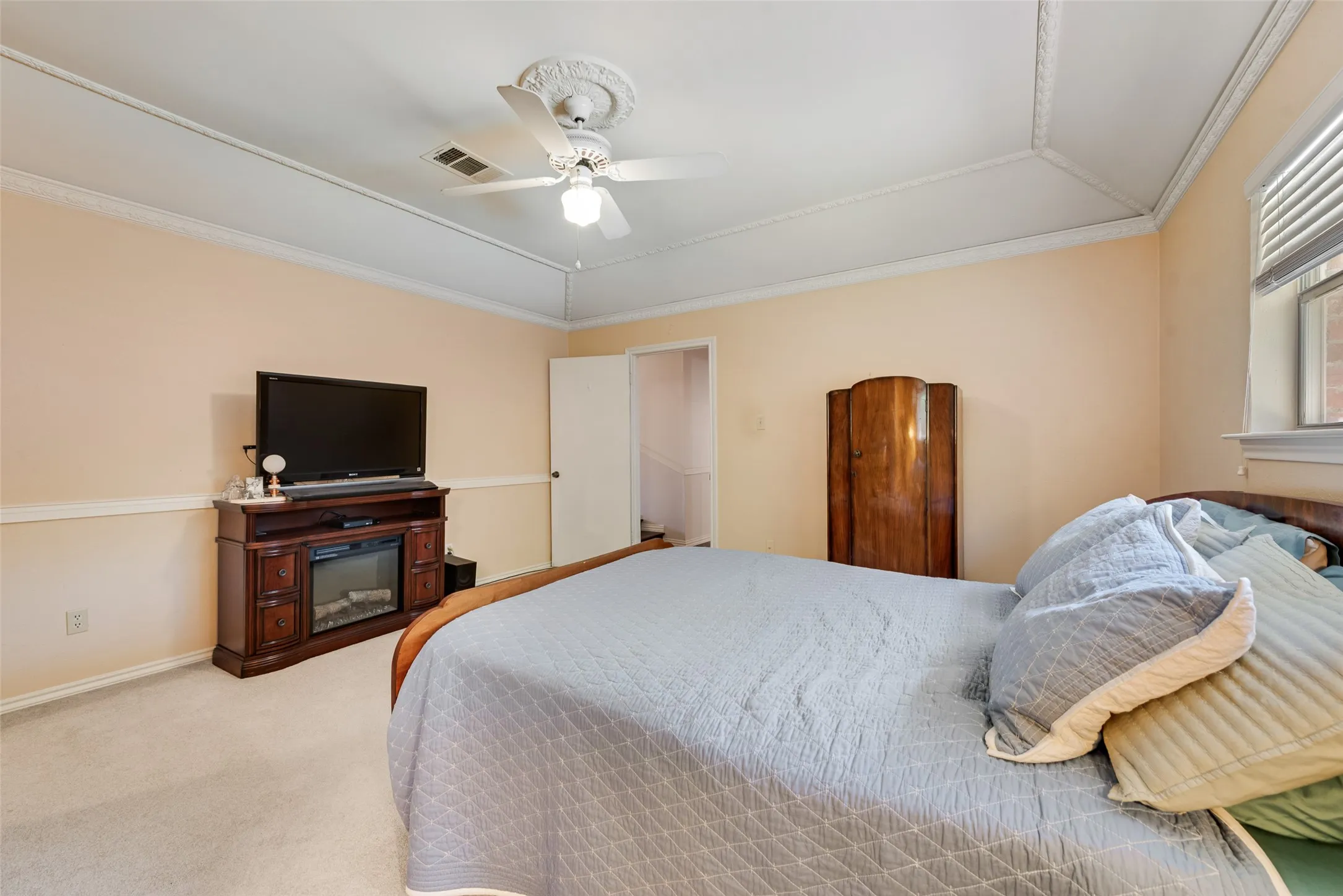 Spacious primary bedroom with vaulted ceiling and large walk-in closet