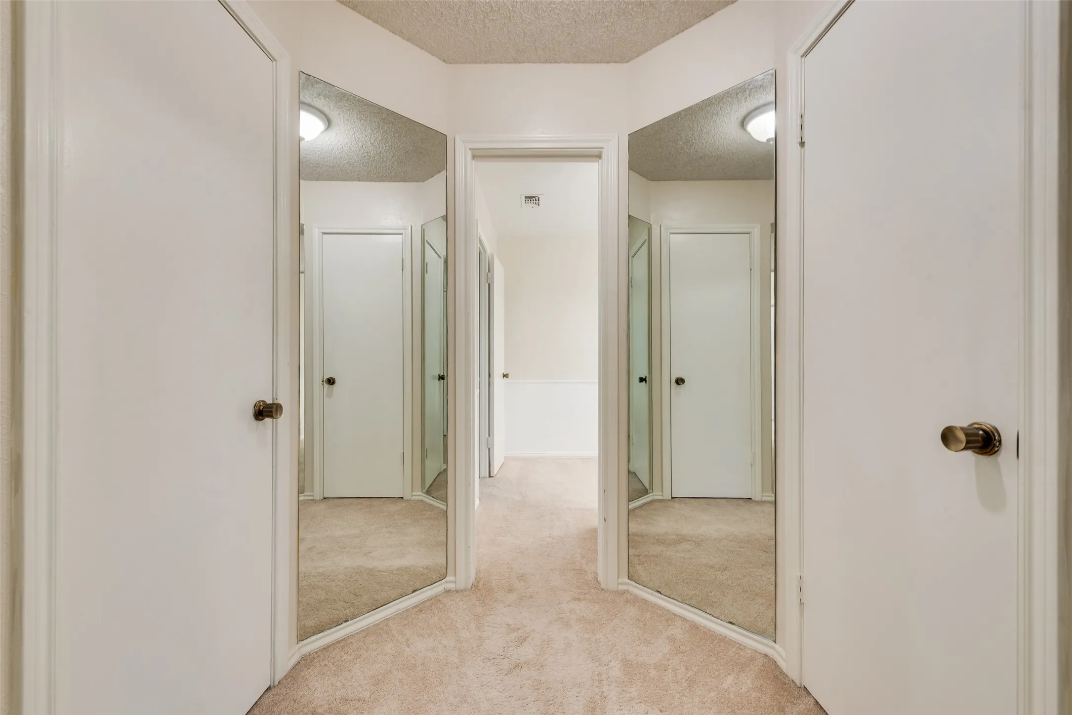 Area between bedrooms upstairs with full length mirrors and walk-in closets