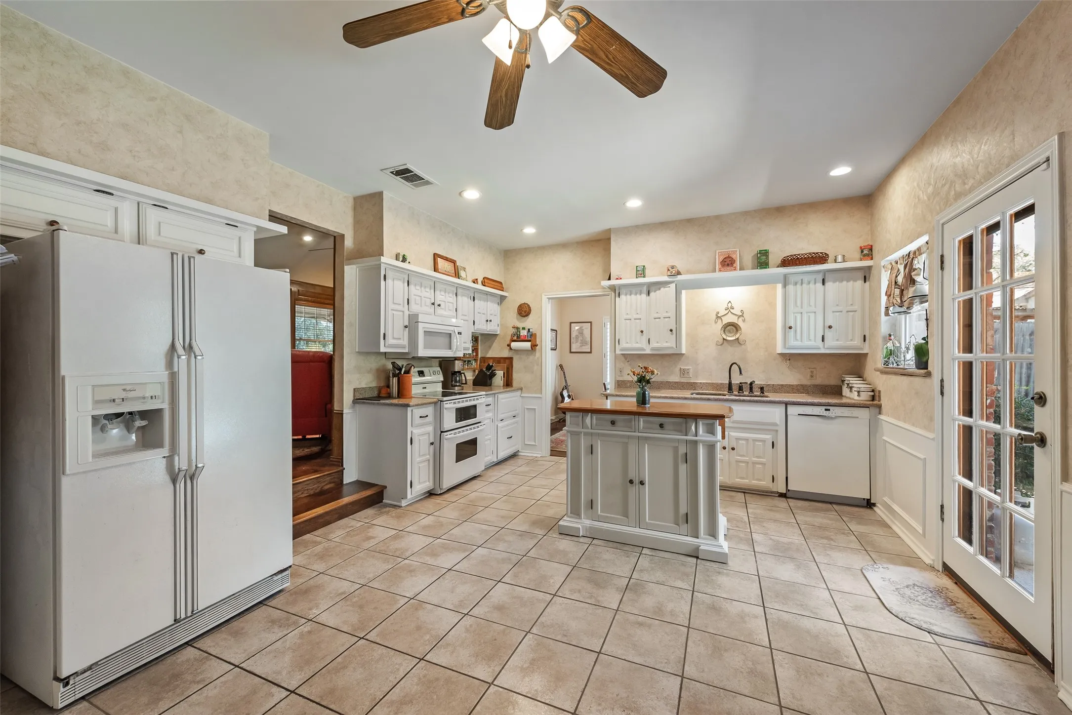 Spacious kitchen with enough room for an eat-in kitchen. Also, access to the backyard and pool.