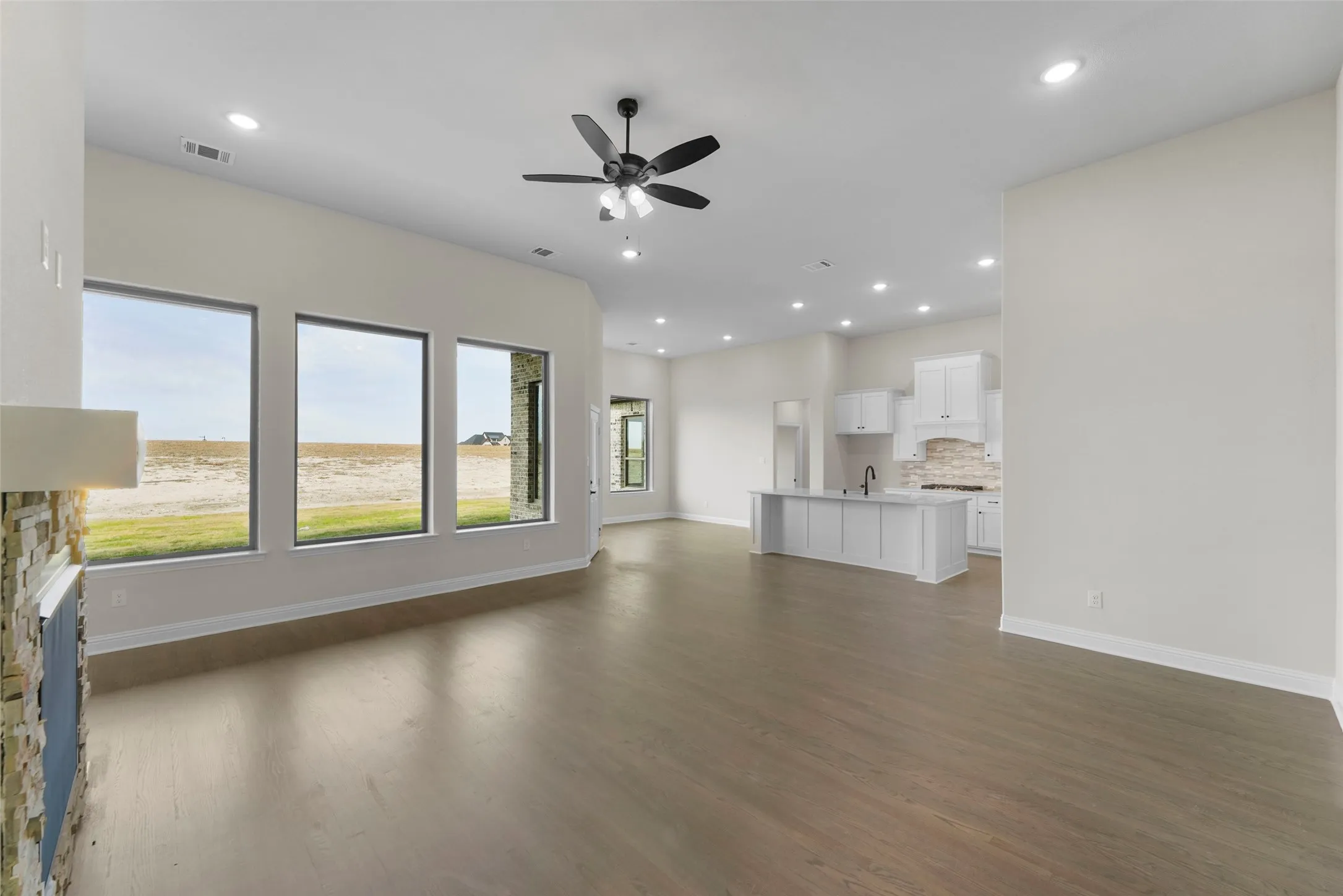 Open concept living space featuring wood-finish flooring, recessed lighting, and a ceiling fan