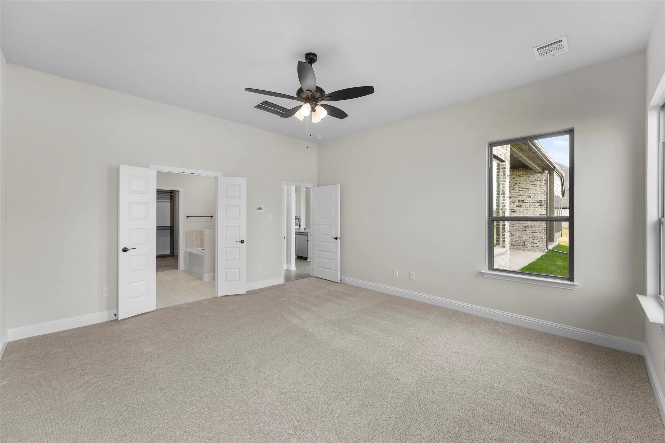 Spacious interior with neutral carpeting and light-colored walls