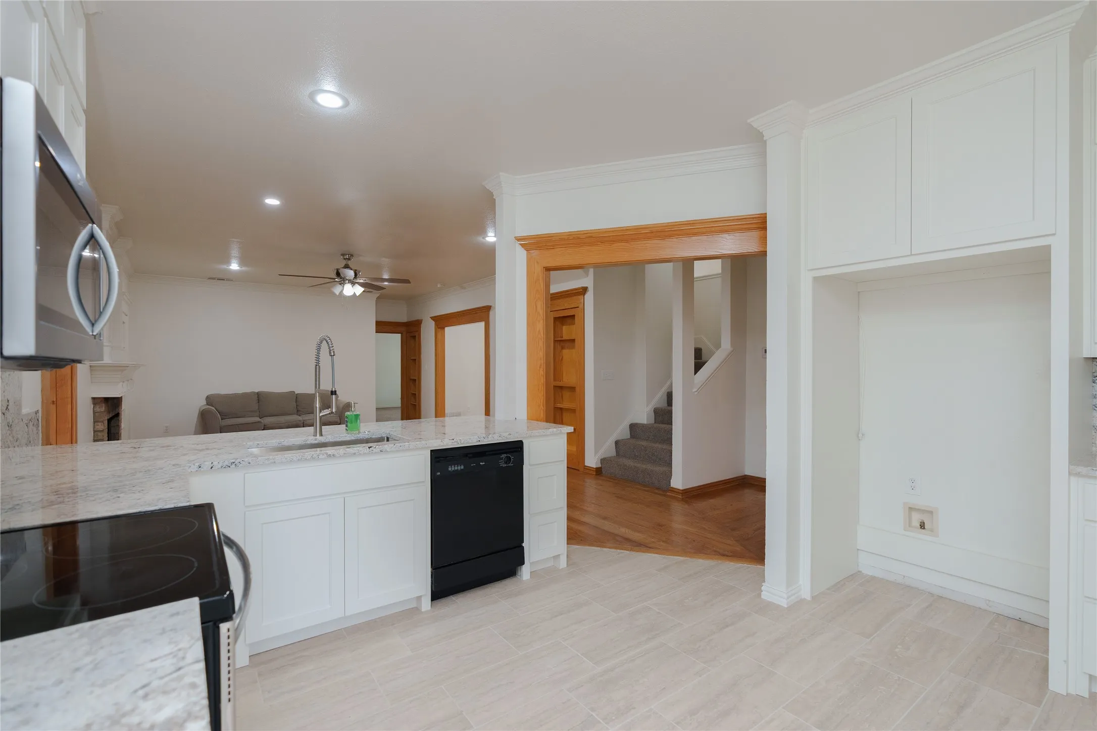 View of kitchen looking into Living area with fireplace.