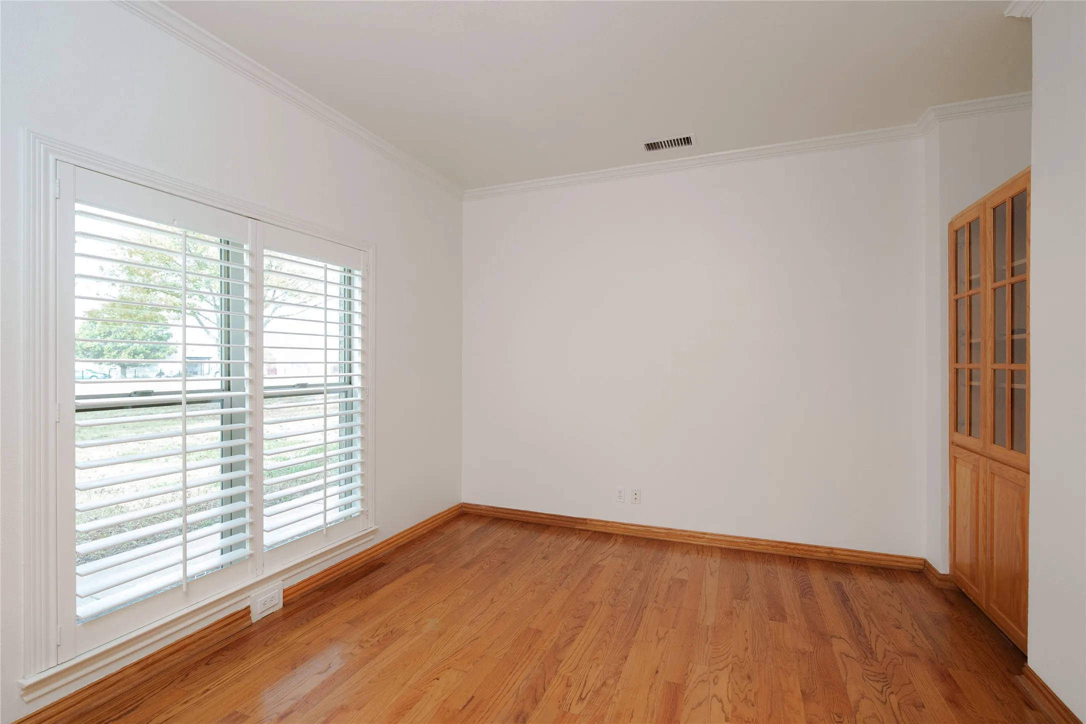 Office area off of the entry with a built in book shelf.