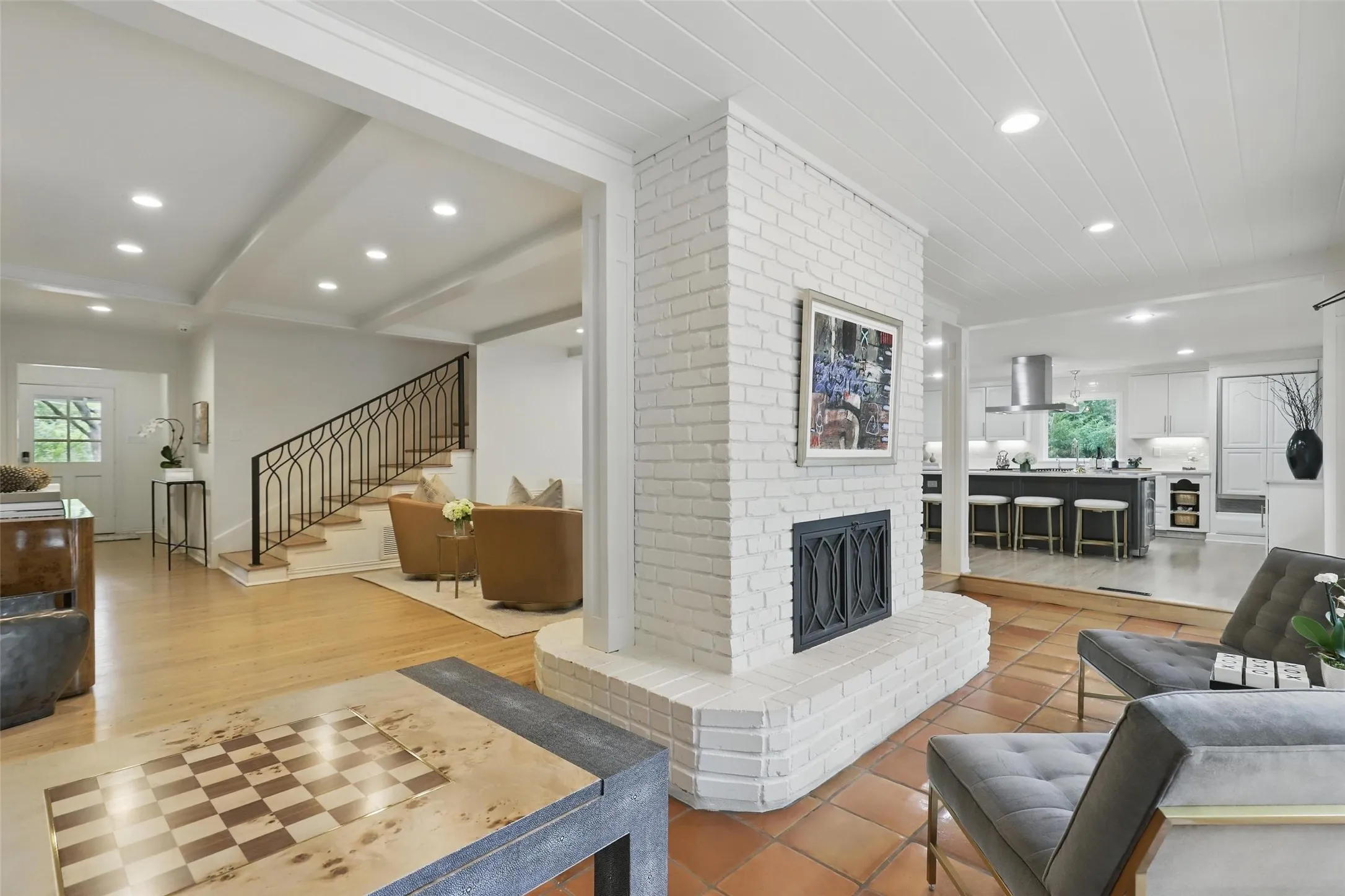 Living area featuring stairs, beamed ceiling, recessed lighting, and a fireplace