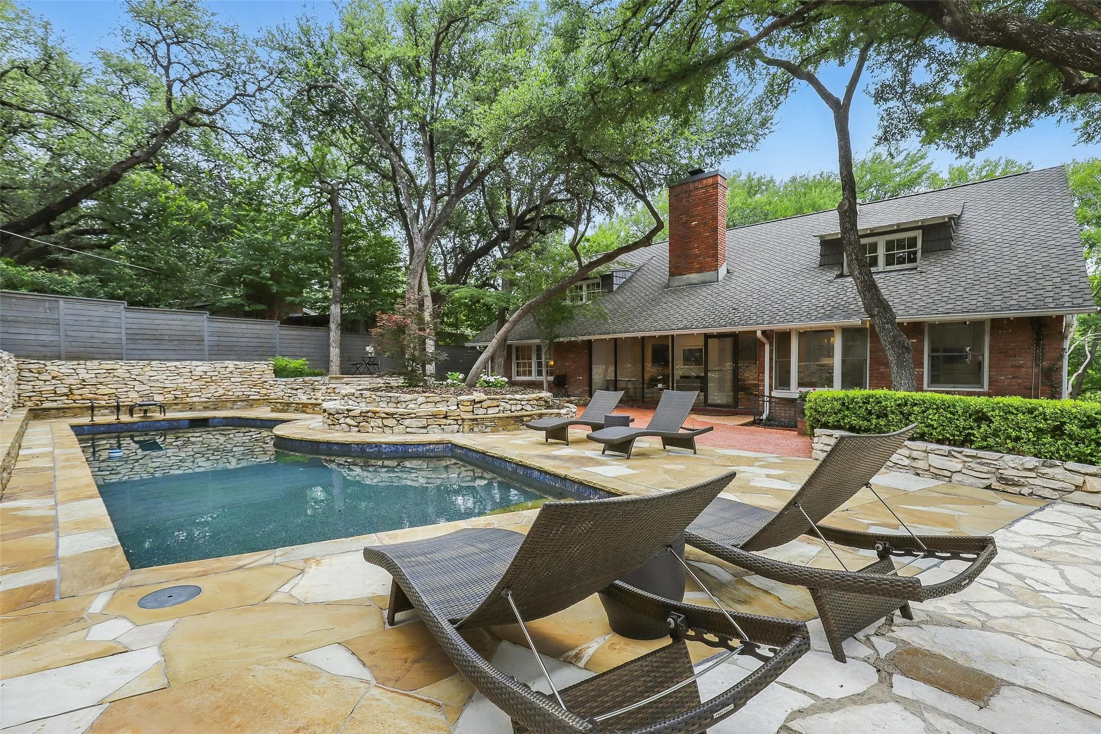 View of swimming pool with a patio, a sunroom, and a fenced backyard