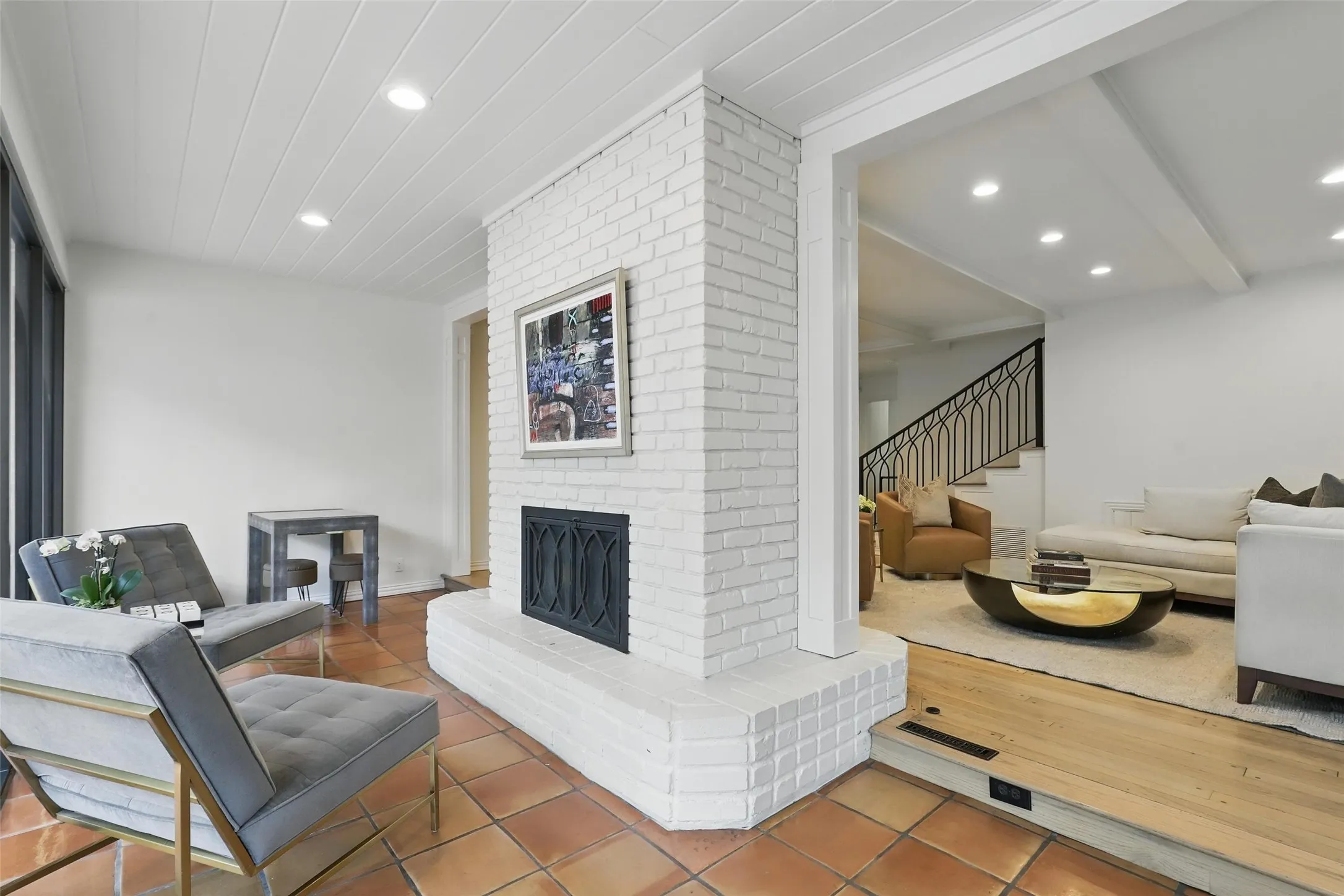 Tiled living room with a fireplace, stairs, and recessed lighting