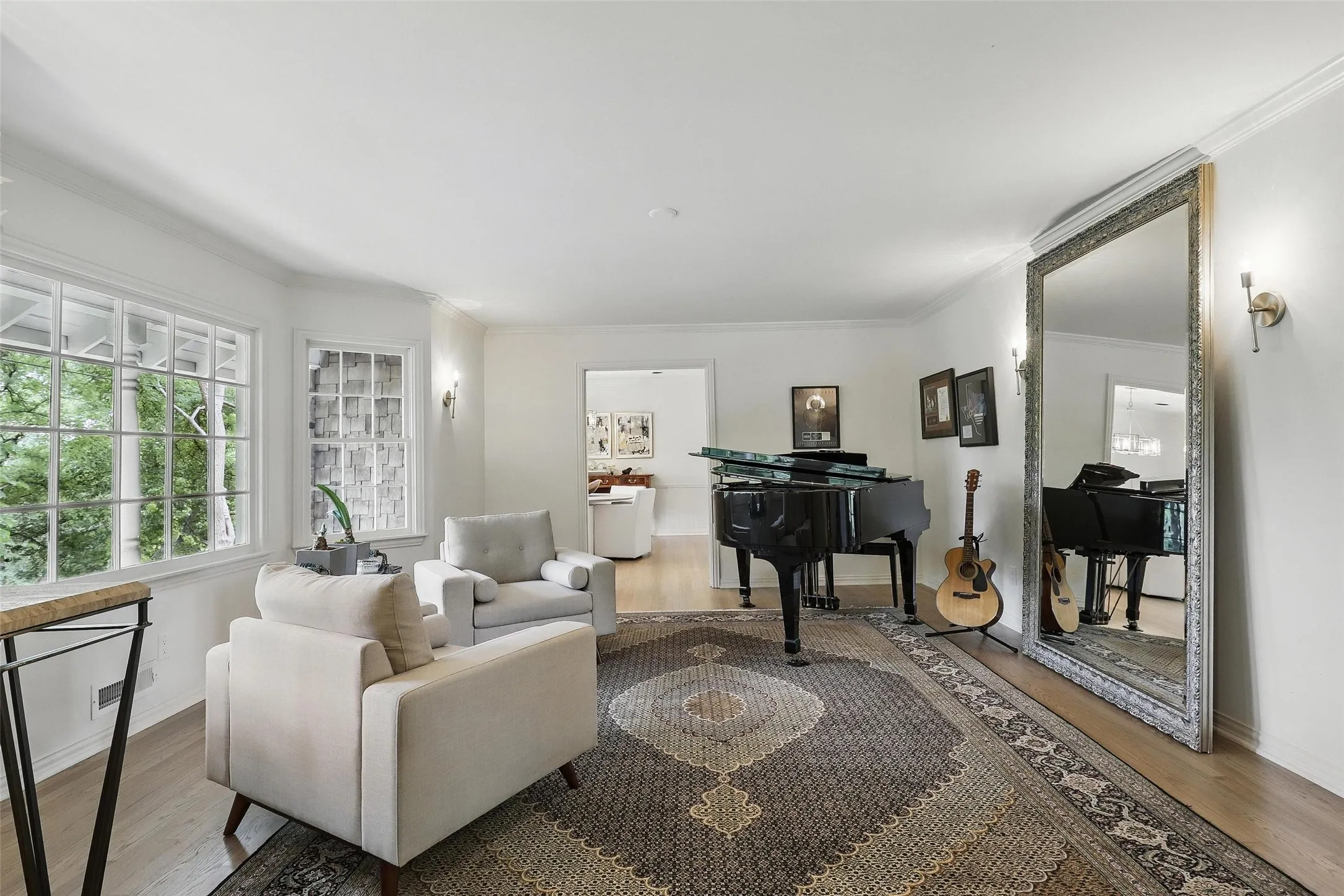 Living area featuring ornamental molding and wood finished floors