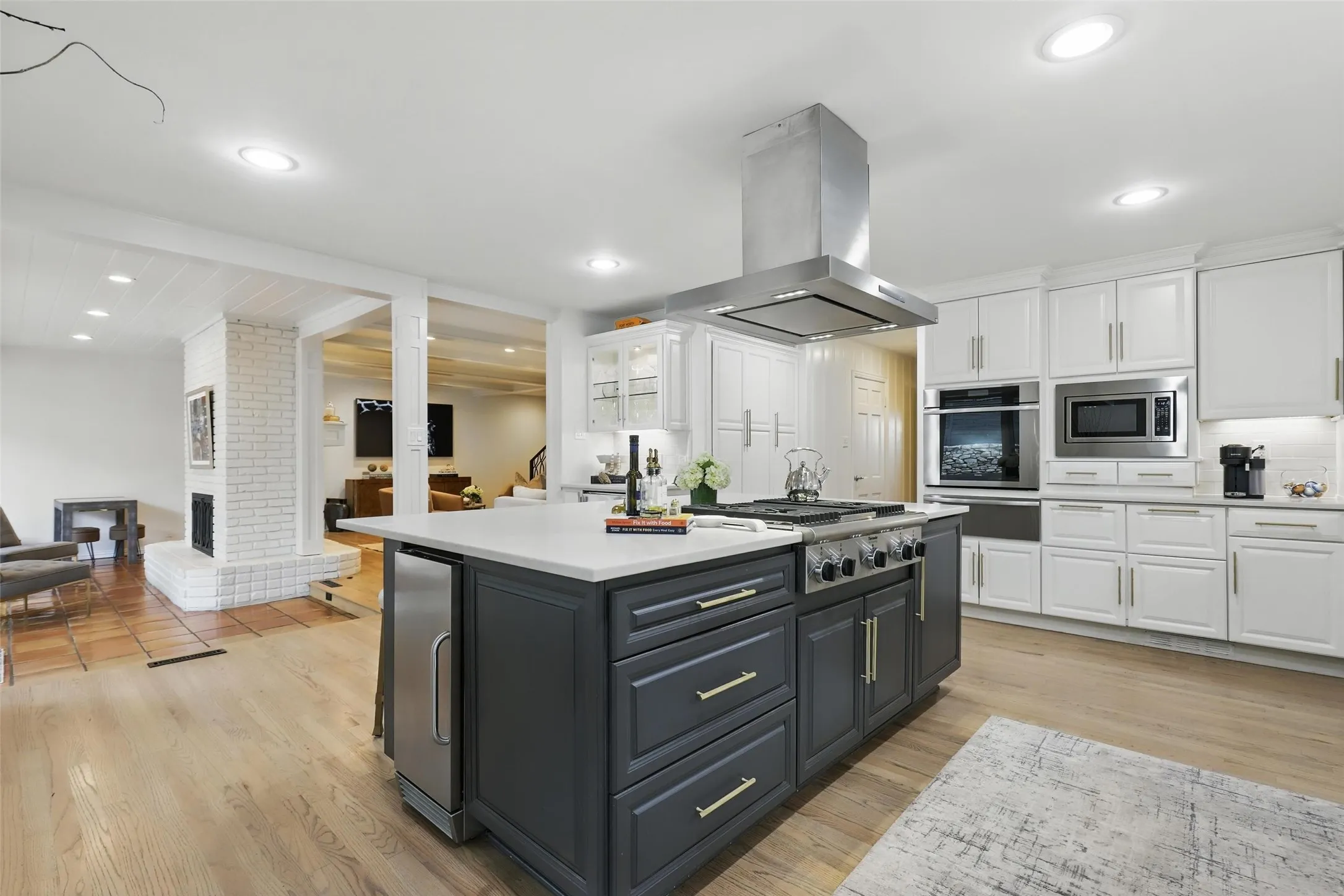 Kitchen featuring white cabinetry, a center island, appliances with stainless steel finishes, island range hood, and recessed lighting