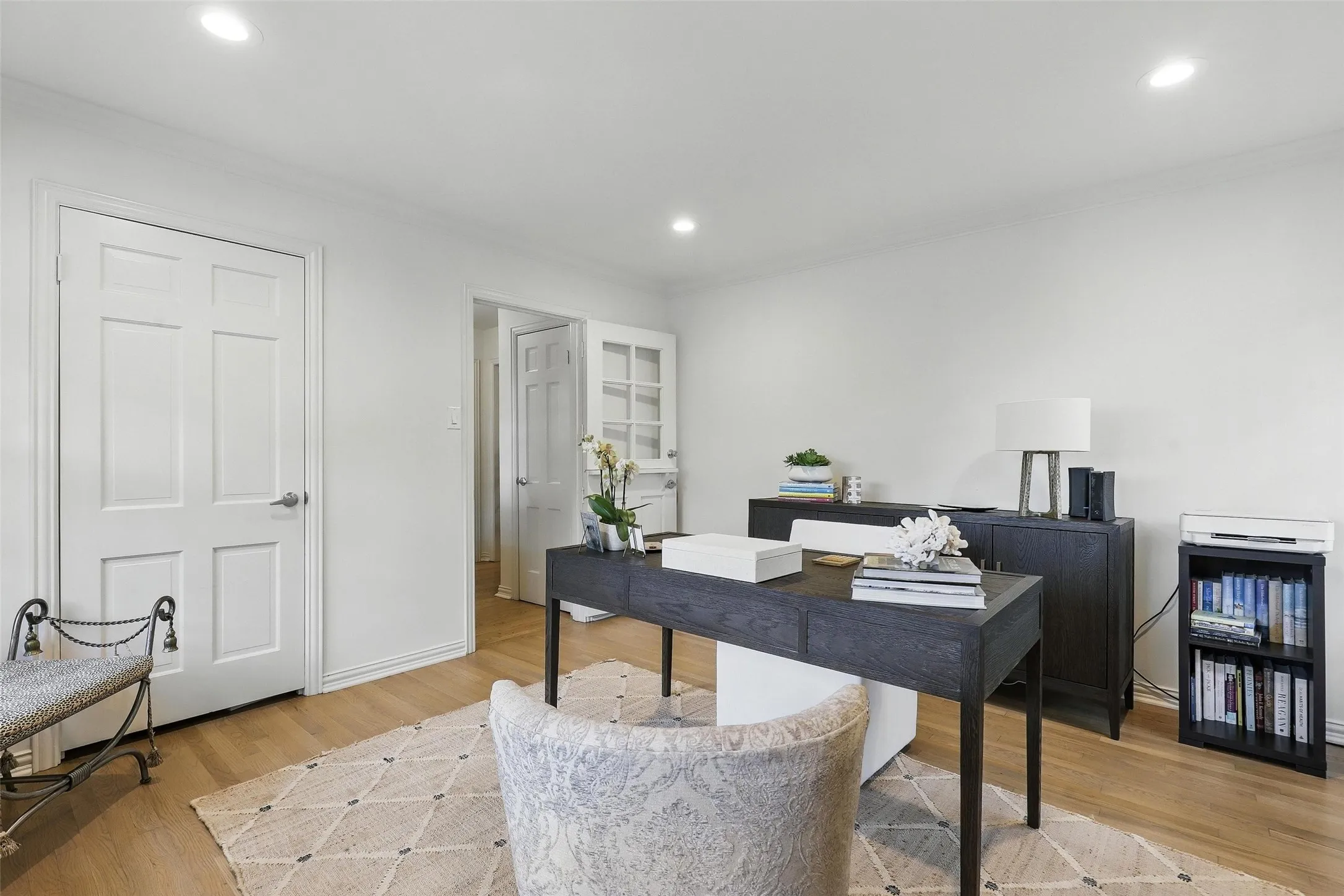 Office area with light wood-style flooring, ornamental molding, and recessed lighting