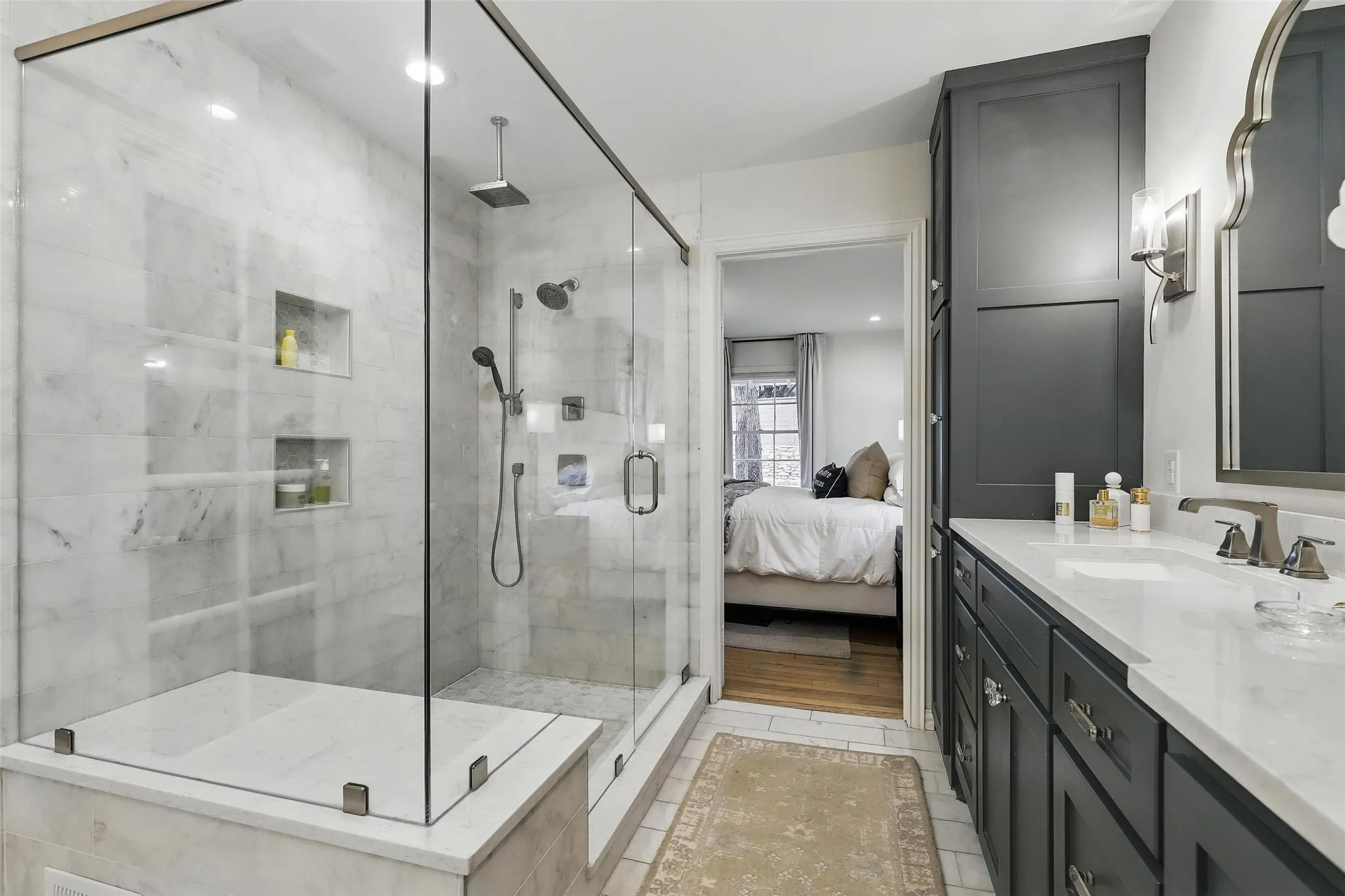 Ensuite bathroom featuring vanity, a shower stall, recessed lighting, and light tile patterned floors