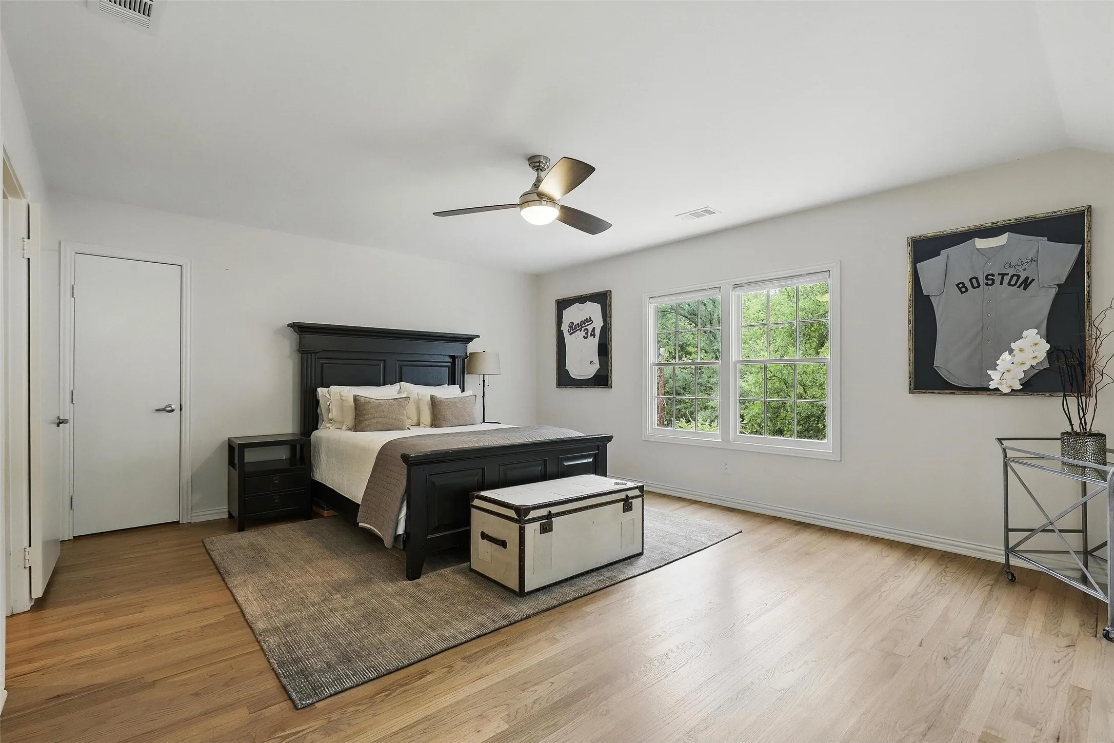 Bedroom with light wood-type flooring and a ceiling fan