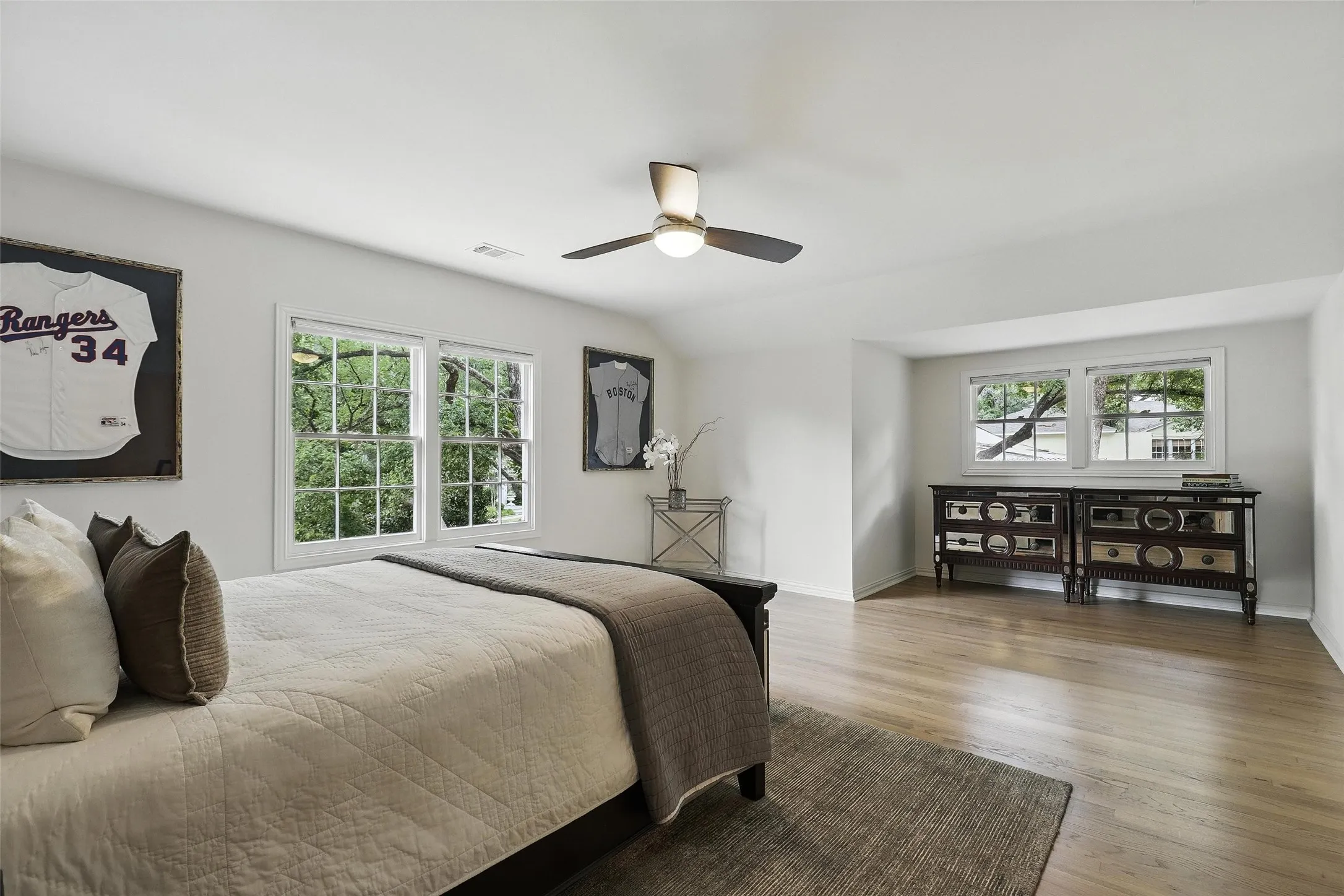 Bedroom with wood finished floors, ceiling fan, and lofted ceiling