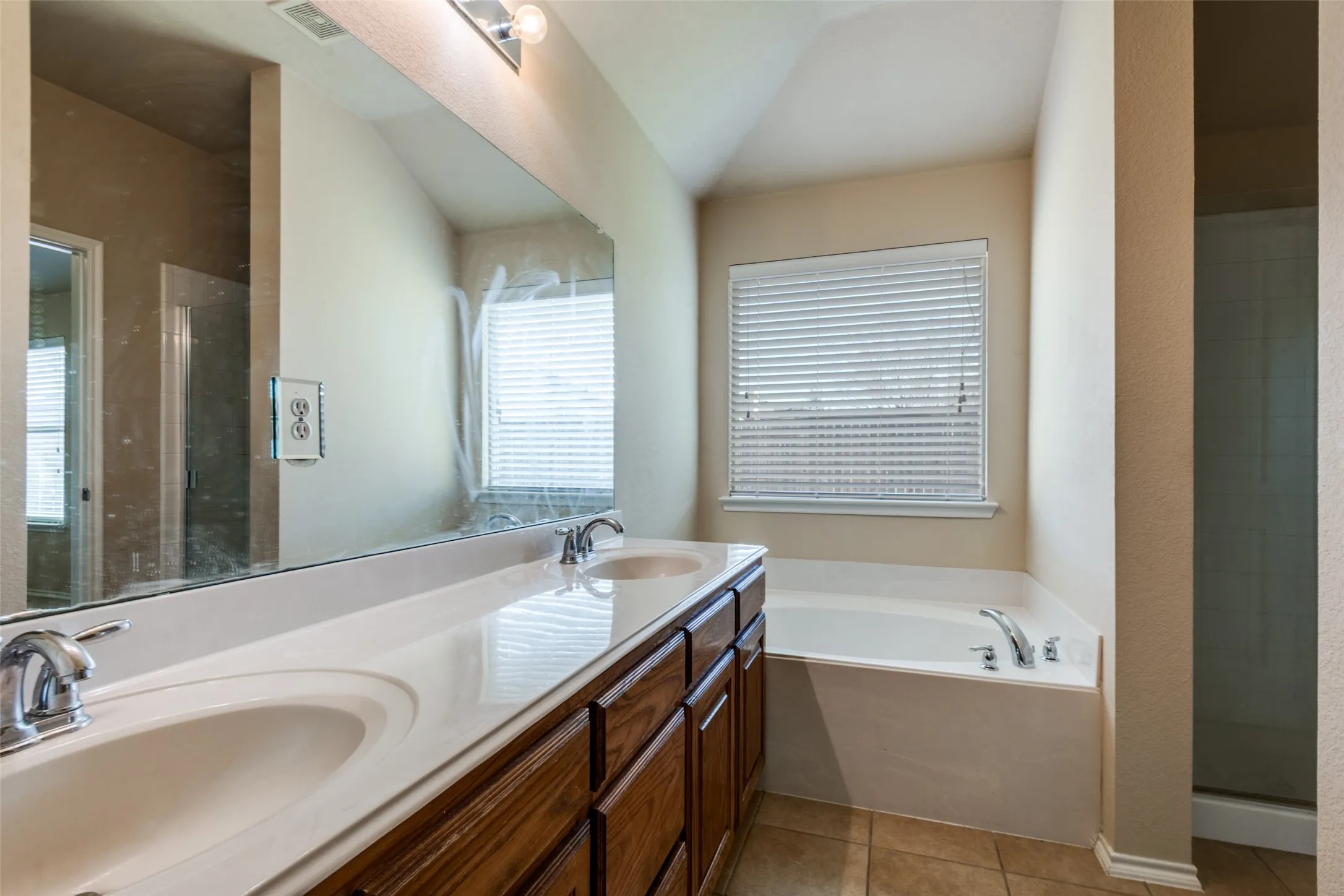 Double vanity featuring integrated sinks and chrome fixtures