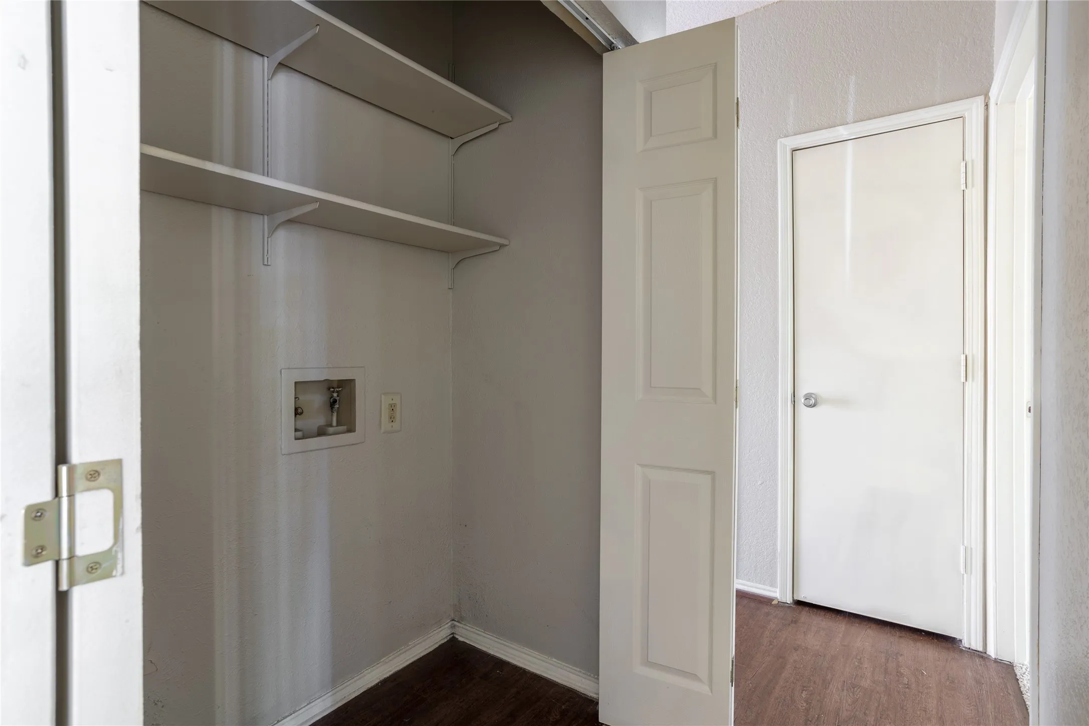 Laundry room with dark wood-style flooring and washer hookup