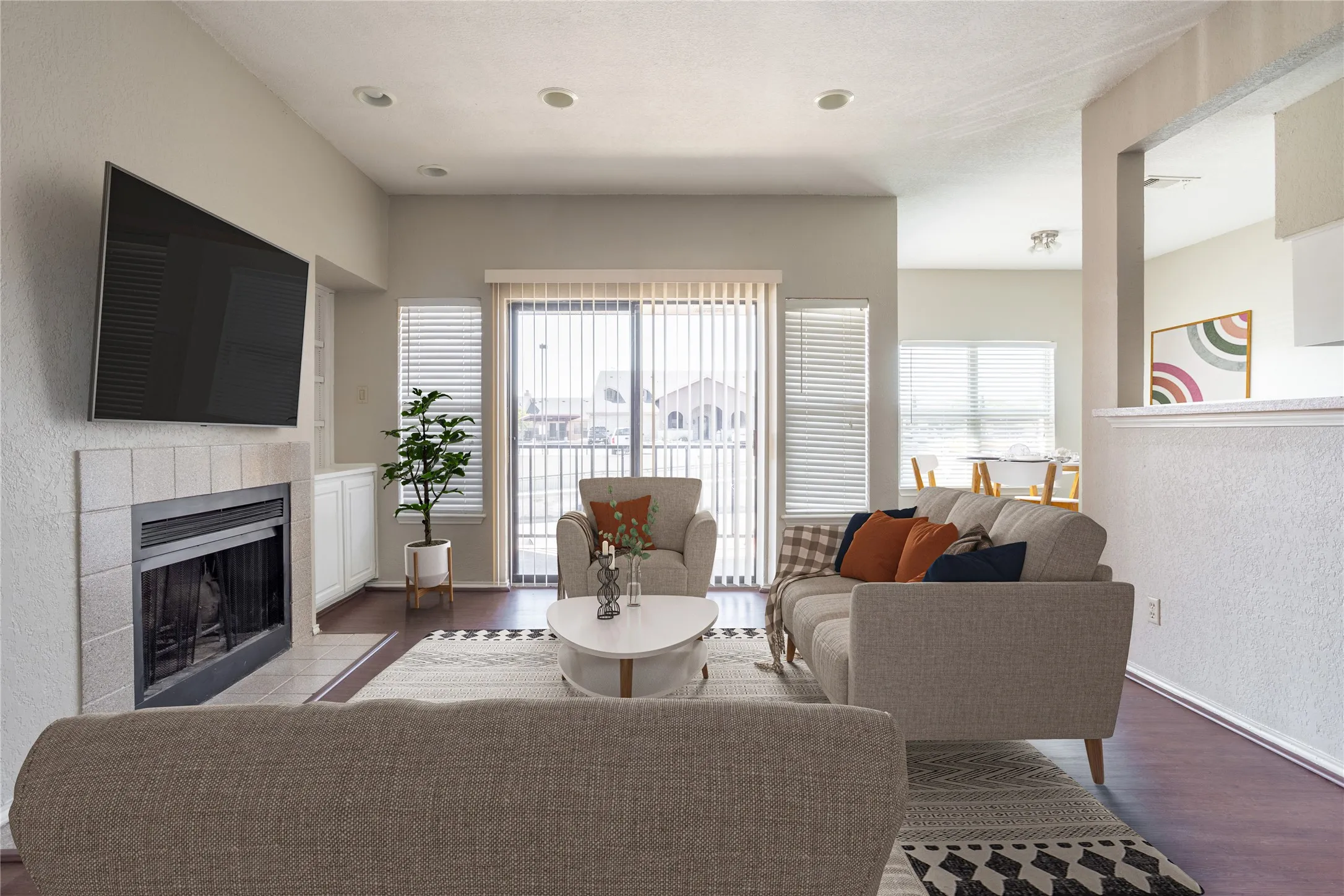 Living room featuring wood finished floors and a tiled fireplace