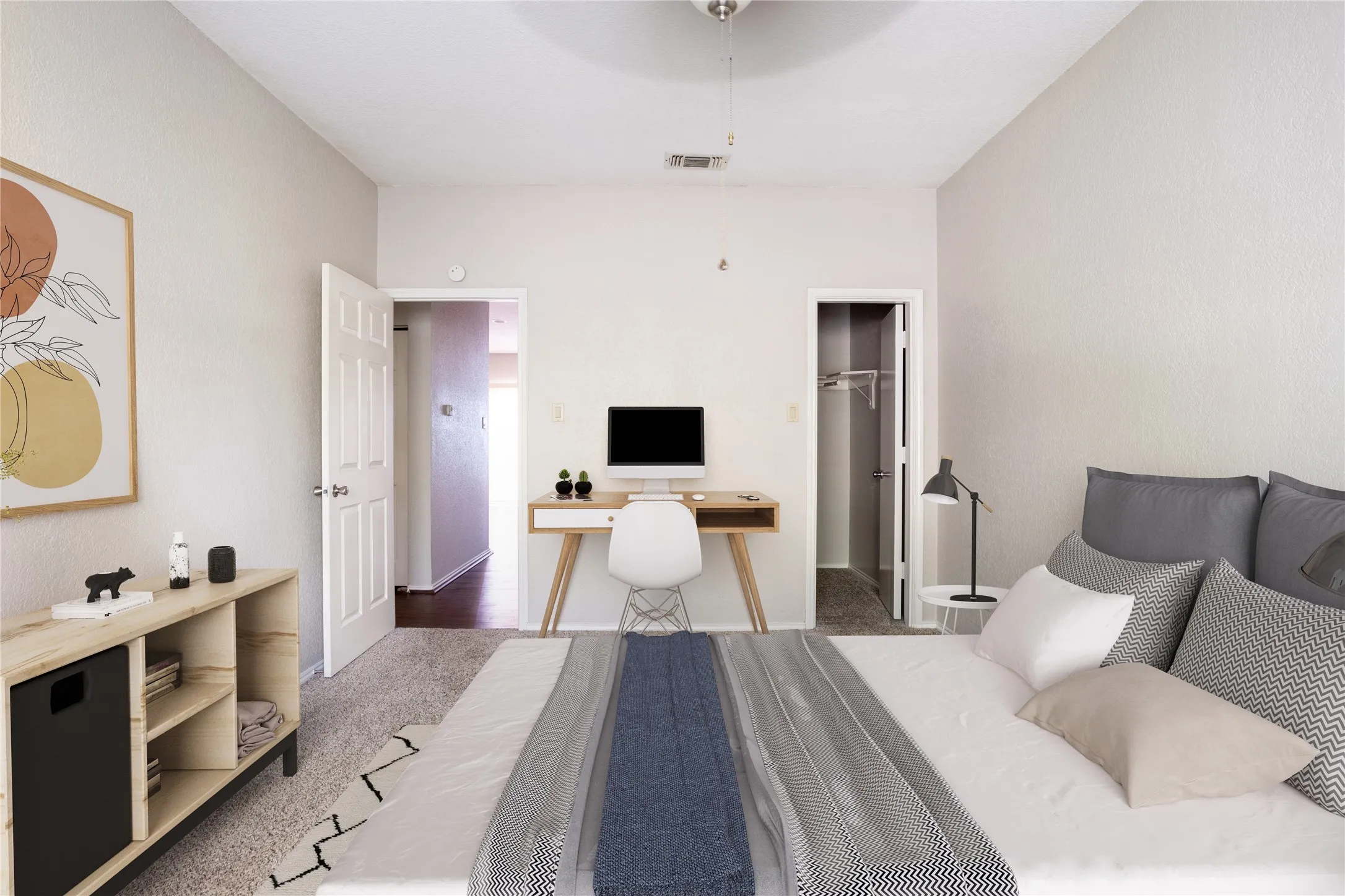 Carpeted bedroom featuring a walk in closet, an office area, and ceiling fan